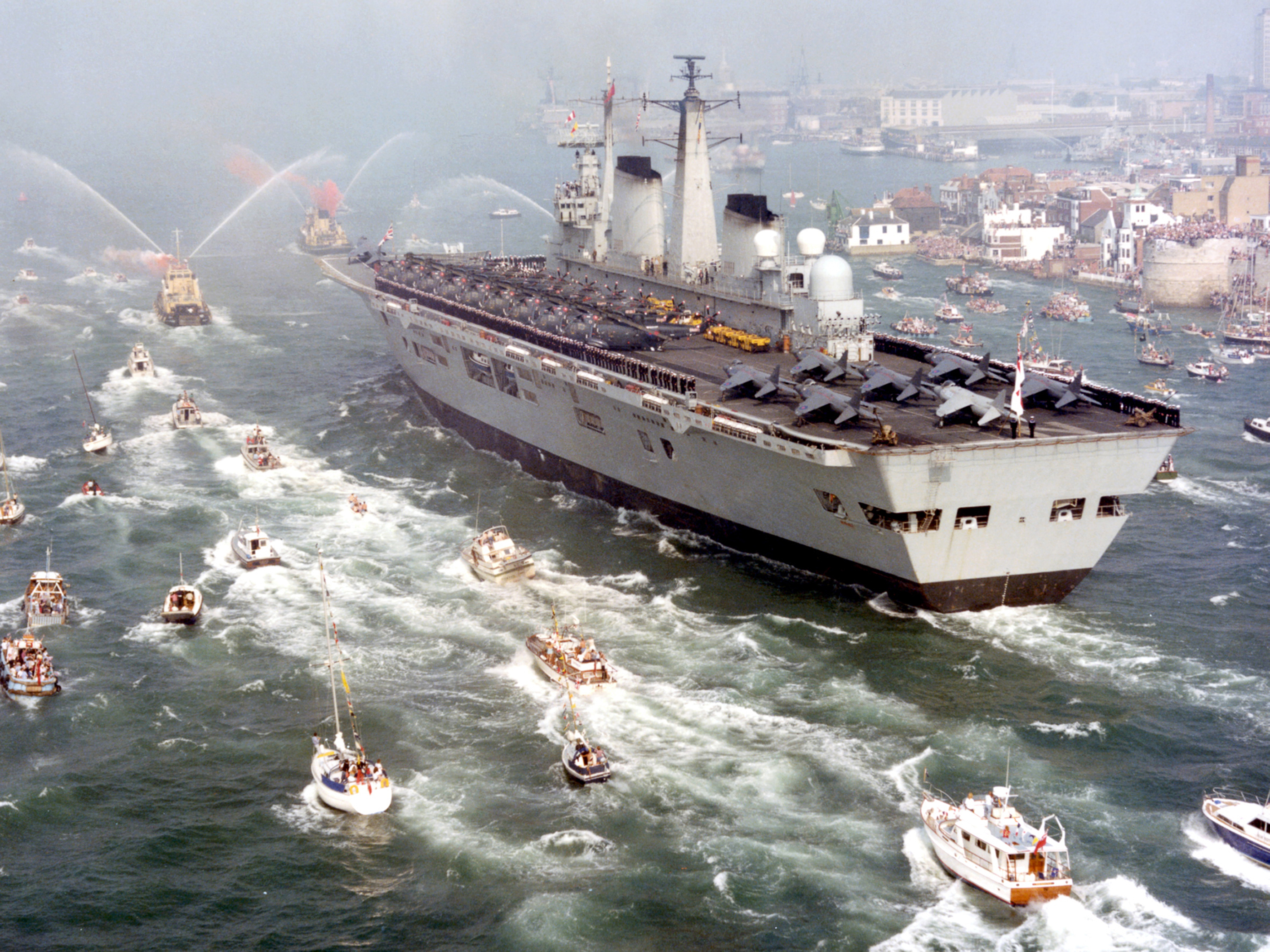 HMS Invincible returns after defeating Argentine forces in the Falklands War in 1982.