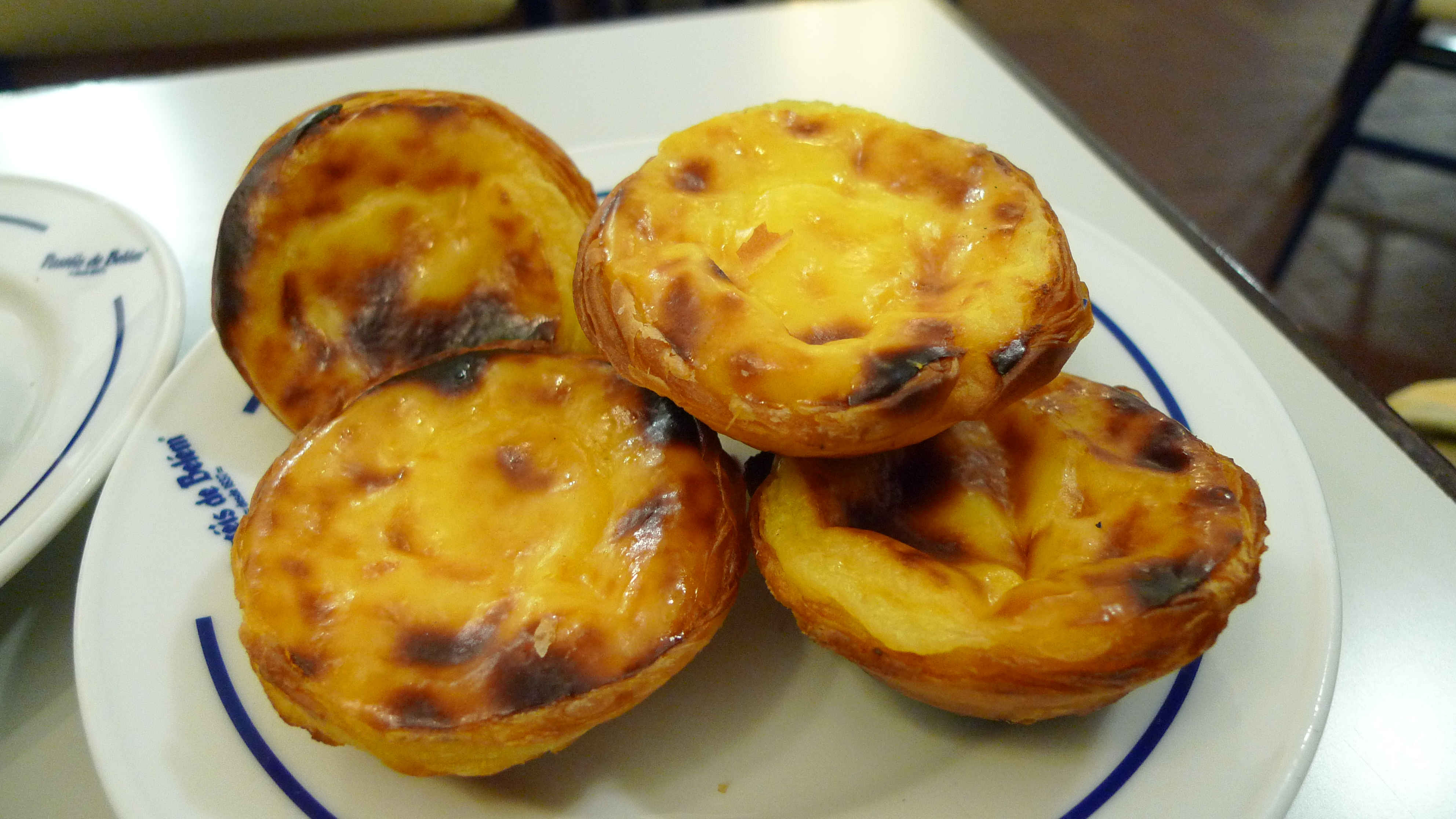 Pastéis de nata, iconic Portuguese custard tarts, enjoyed in Lisbon and globally.