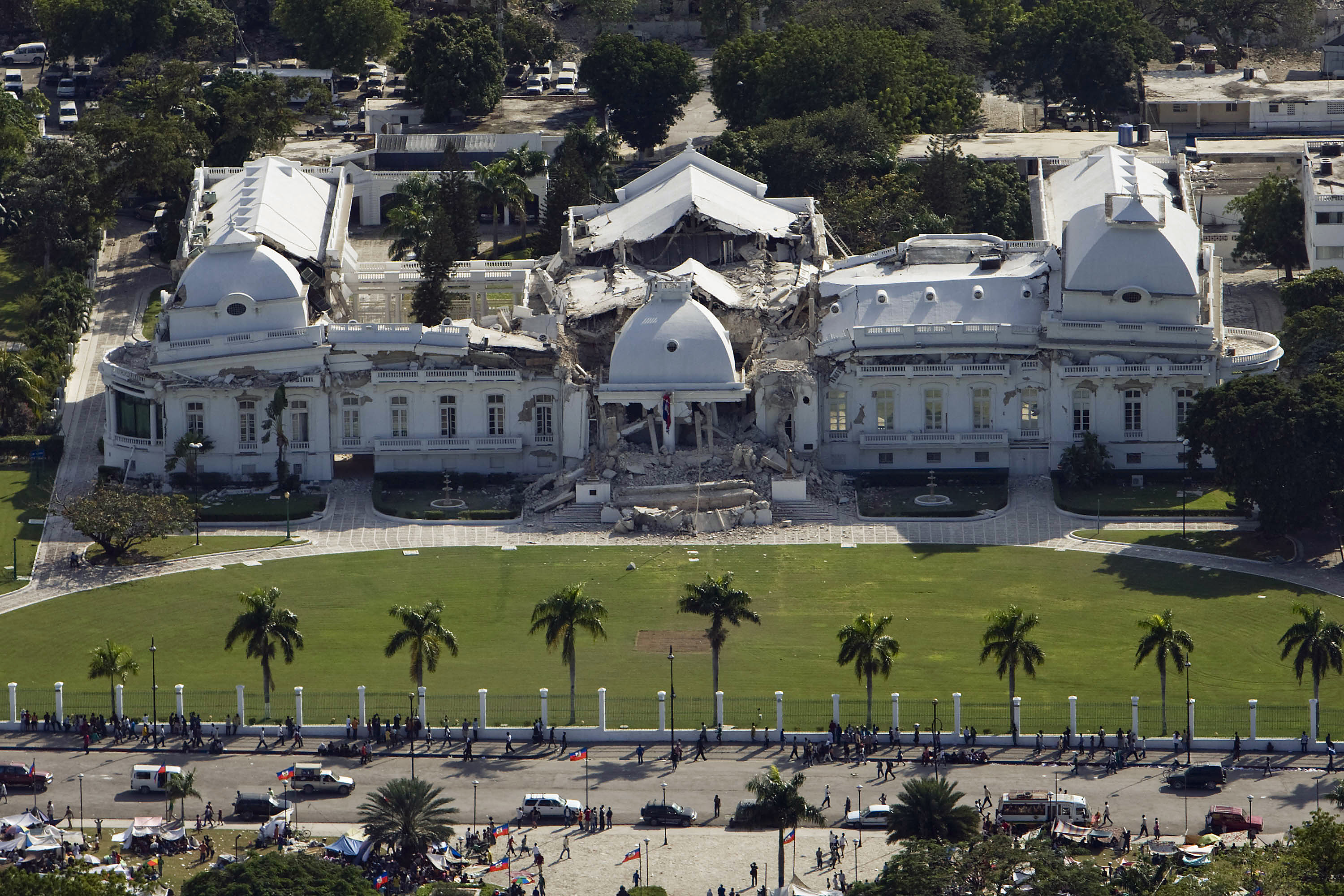 The Haitian National Palace in Port-au-Prince, heavily damaged after the 2010 Haiti earthquake. The second story completely collapsed, symbolizing the devastation to the nation's infrastructure and governance.