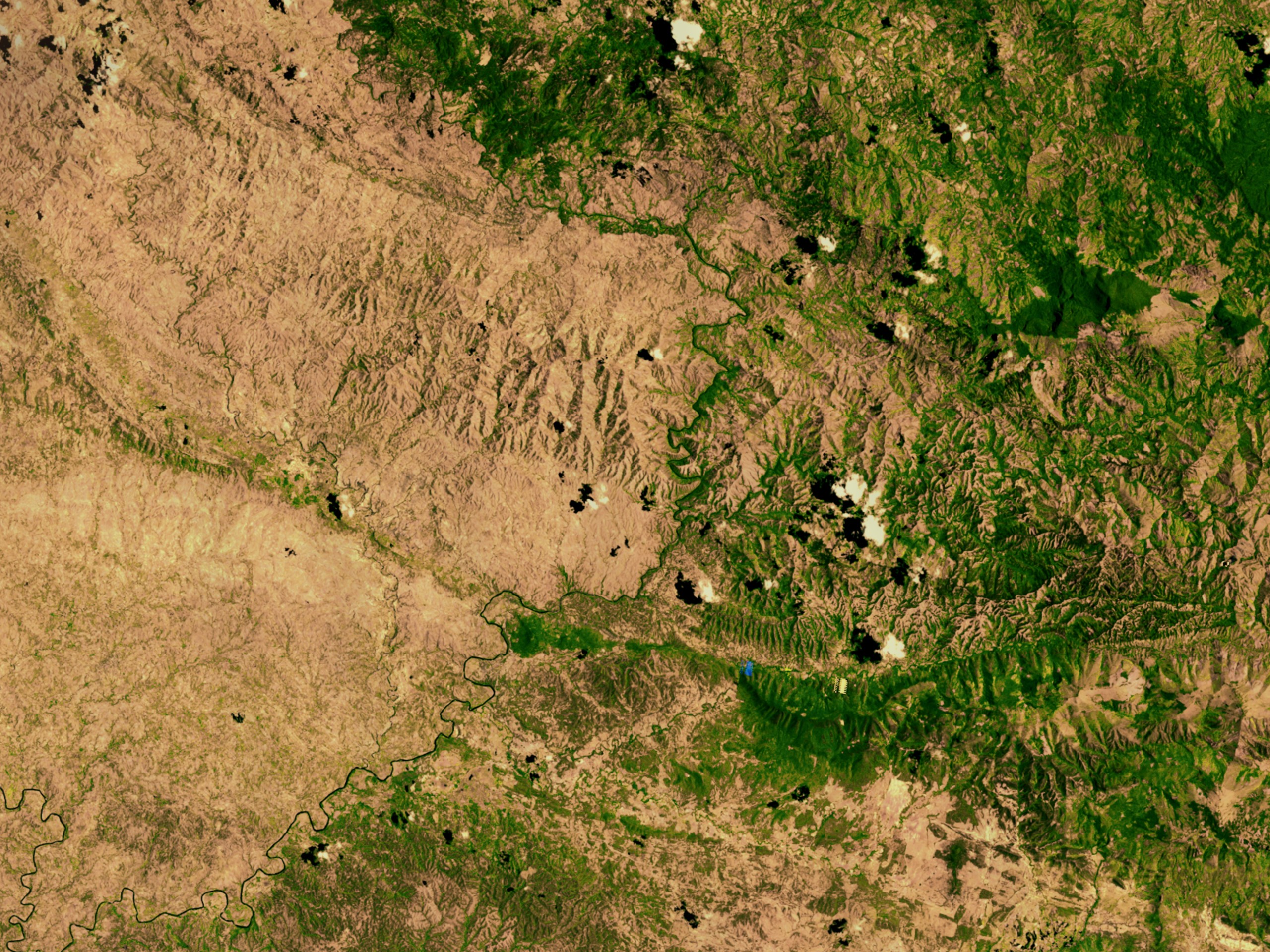 Haiti's border with the Dominican Republic in 2002, starkly showing the extent of deforestation on the Haitian side (left) compared to the more forested Dominican side (right).