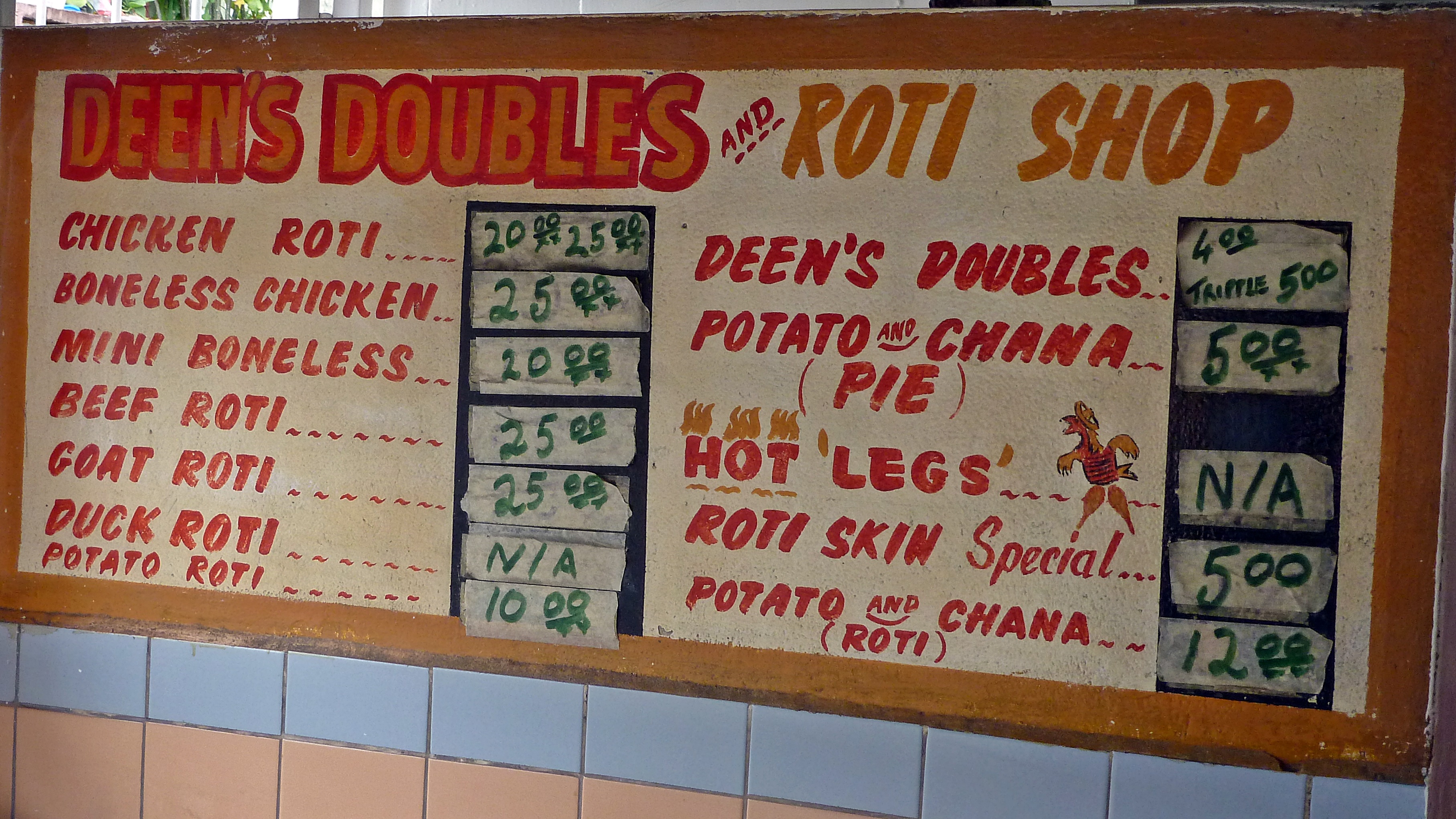 A menu for Doubles, a popular street food, showcasing local culinary enterprise and cultural heritage. Many restaurants serve Trinidad and Tobago dishes such as Roti or doubles. Fresh cut coconut water and jelly are other popular items.