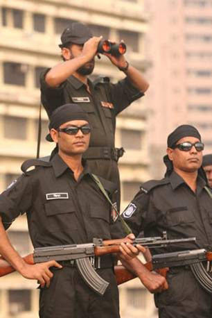 Armed men in black uniforms of the Rapid Action Battalion (RAB). The RAB has faced accusations of extrajudicial killings, enforced disappearances, and other human rights abuses, leading to sanctions from the United States Department of the Treasury in 2021.