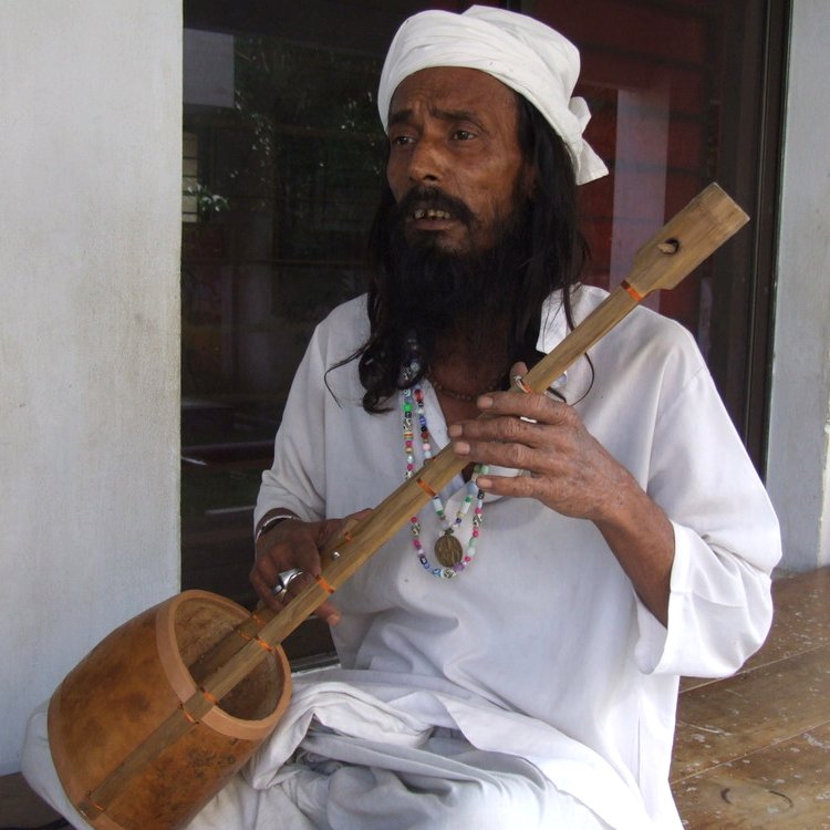 A Baul musician playing the ektara, a traditional one-stringed instrument, at the shrine of Lalon in Kushtia.
