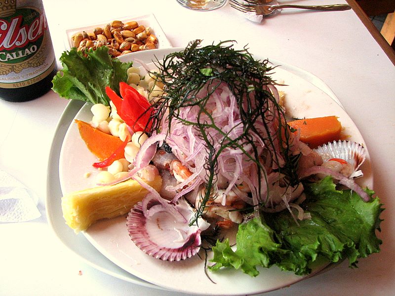 Ceviche, a popular Peruvian dish made from fresh raw fish cured in citrus juices, such as lemon or lime, and spiced with ají, chili peppers or other seasonings including chopped onions, salt, and coriander.