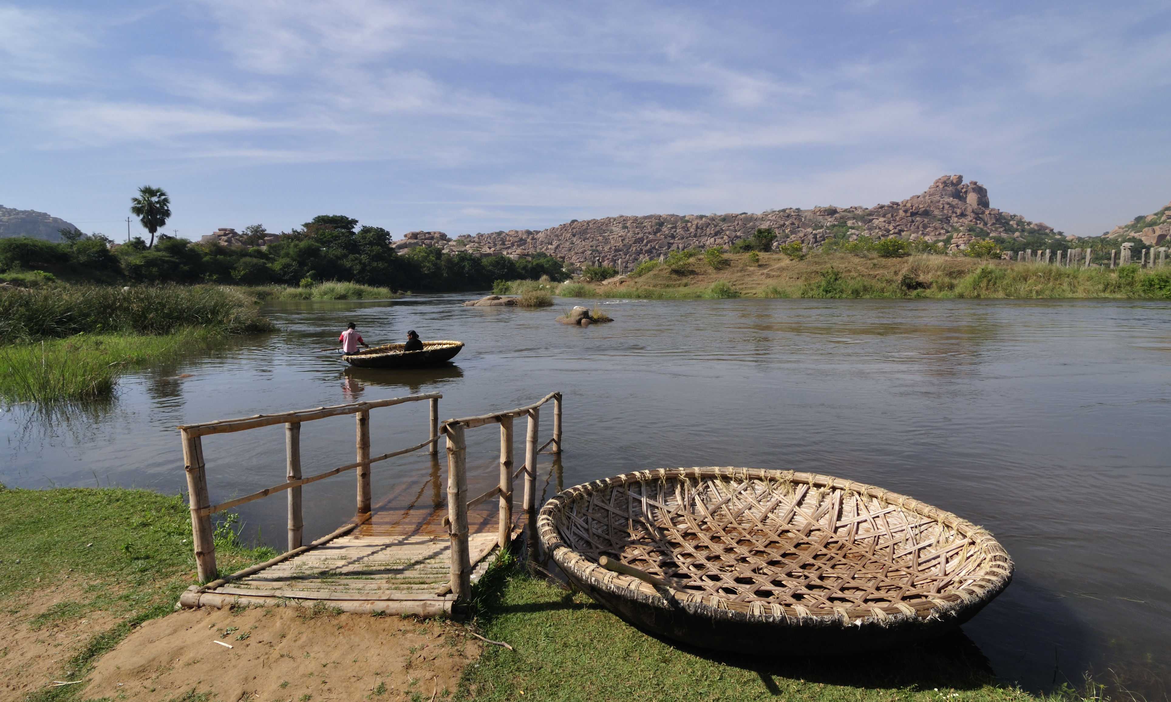 The Tungabhadra River, with rocky outcrops, flows into the peninsular Krishna River. The river systems are vital for agriculture and livelihoods but also face pollution and water management issues.