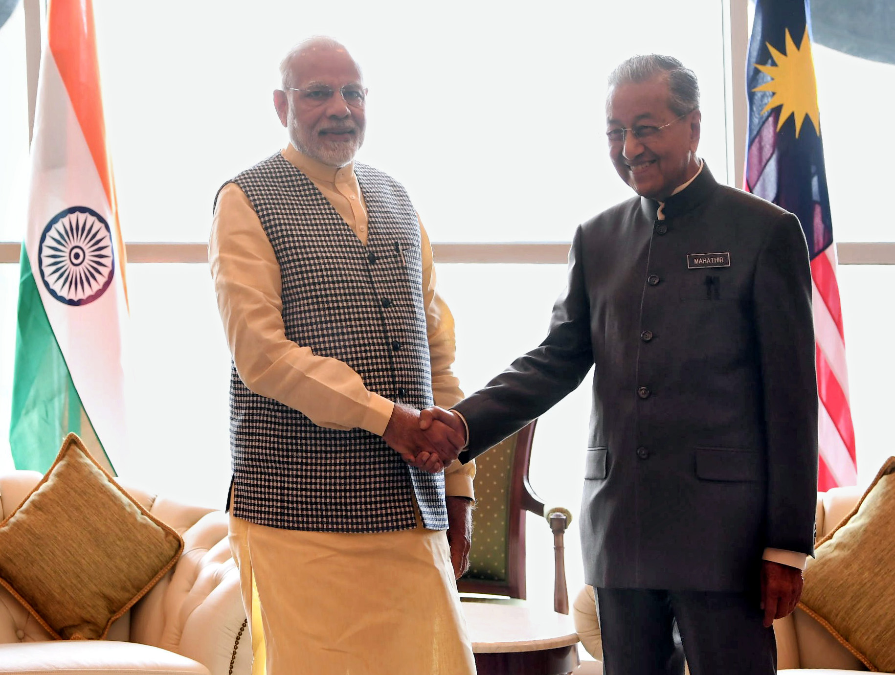 Prime Minister Narendra Modi of India (left, background) in talks with Prime Minister Mahathir Mohamad of Malaysia during a visit to Malaysia, 2016, showcasing India's 