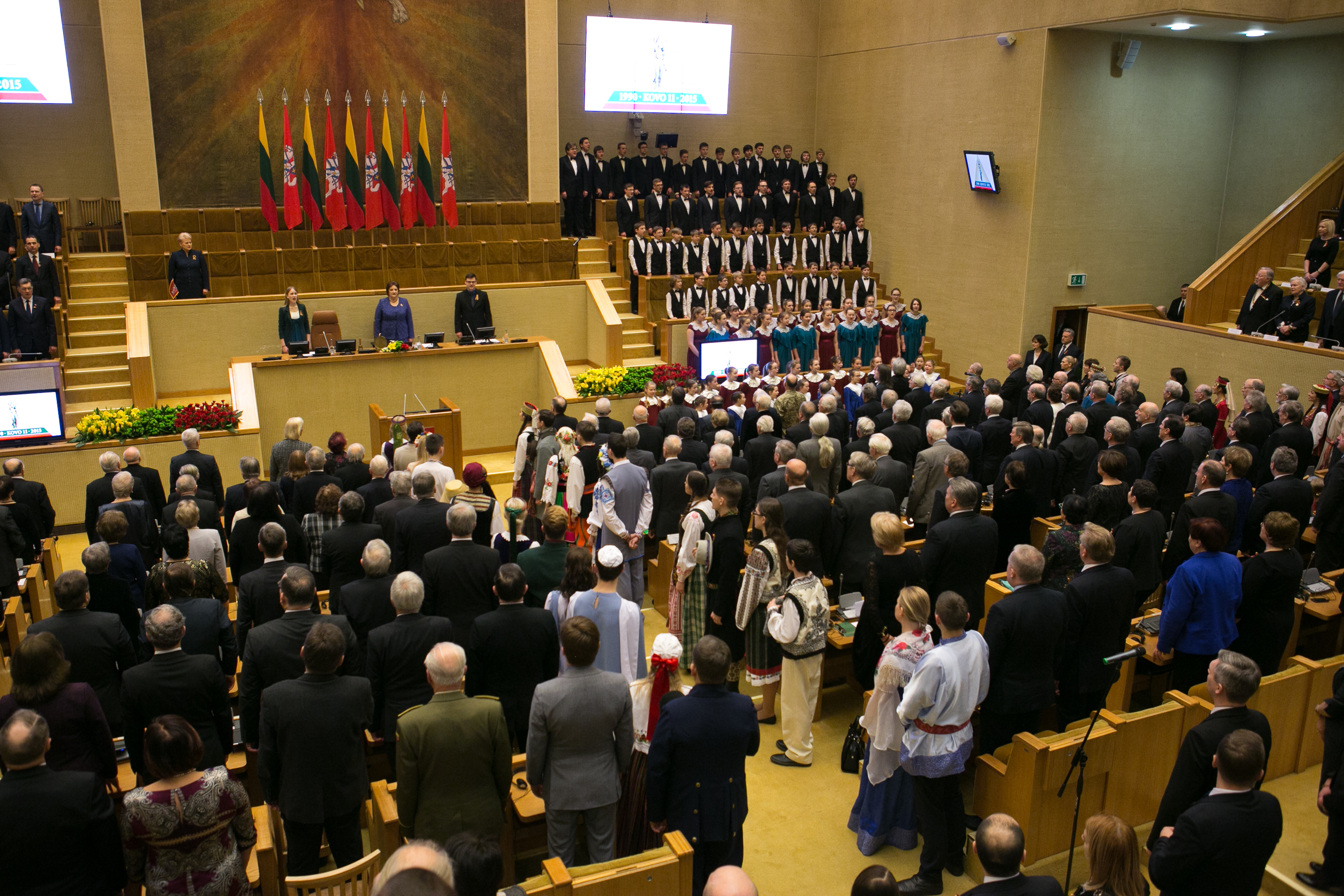 Commemoration of the Act of the Re-Establishment of the State of Lithuania in the historical Seimas hall where it was originally signed in 1990. The ceremony highlights Lithuania's commitment to its restored democratic sovereignty.