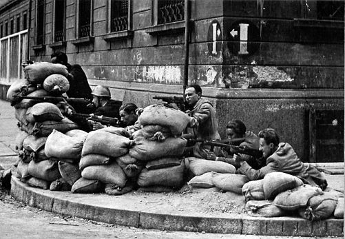 Italian partisans in Milan during the final insurrection leading to the liberation of Italy in April 1945. Their struggle against Nazi occupation and Fascist collaborators was a crucial chapter in the nation's history.