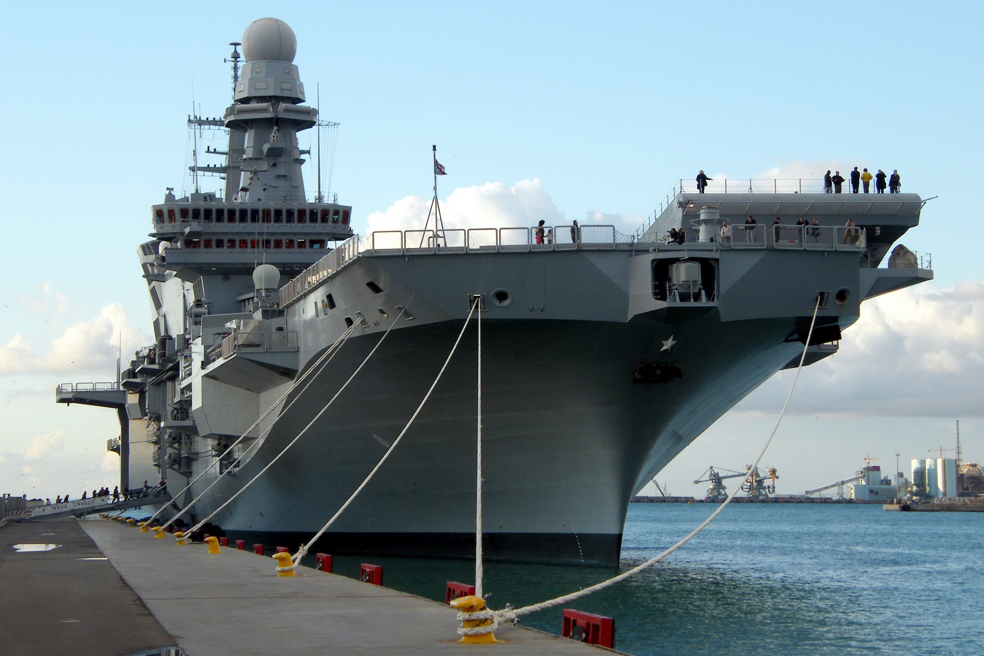 The aircraft carrier Cavour, flagship of the Italian Navy, representing Italy's naval capabilities.