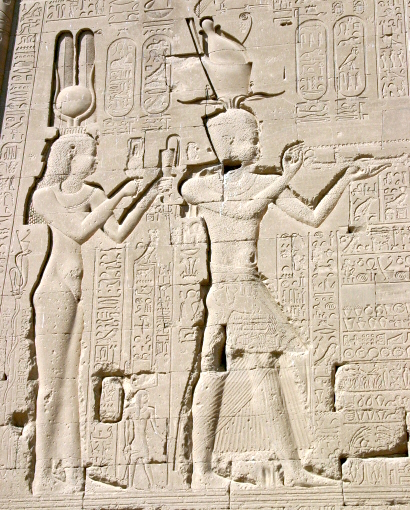 The Ptolemaic Queen Cleopatra VII and her son by Julius Caesar, Caesarion, depicted in Egyptian style at the Temple of Dendera. This illustrates the Ptolemies' adoption of pharaonic traditions to legitimize their rule.