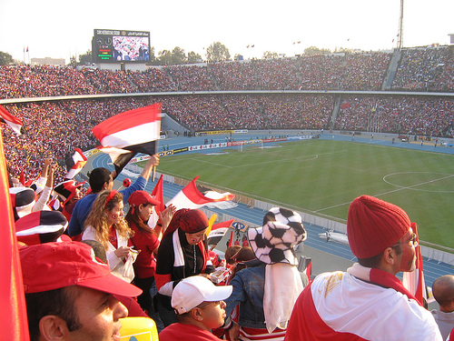 A crowd at Cairo Stadium watching the Egypt national football team, highlighting the immense popularity of football in the country.