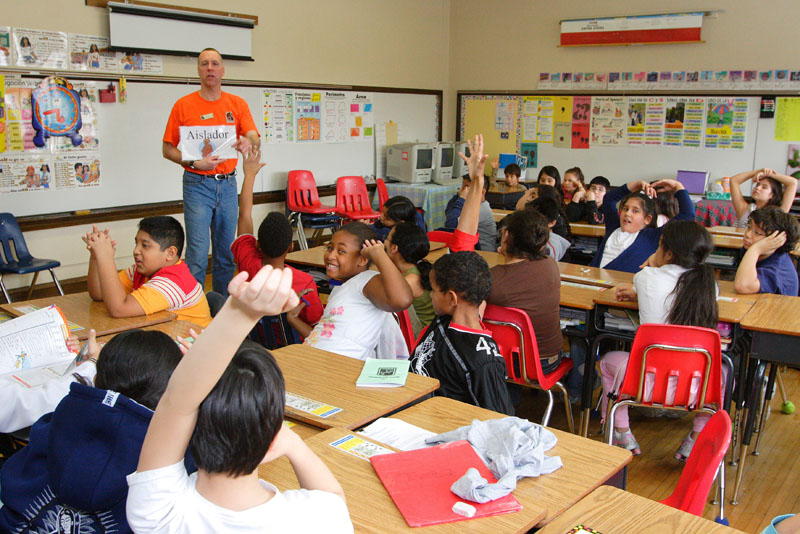 Man teaching a full classroom