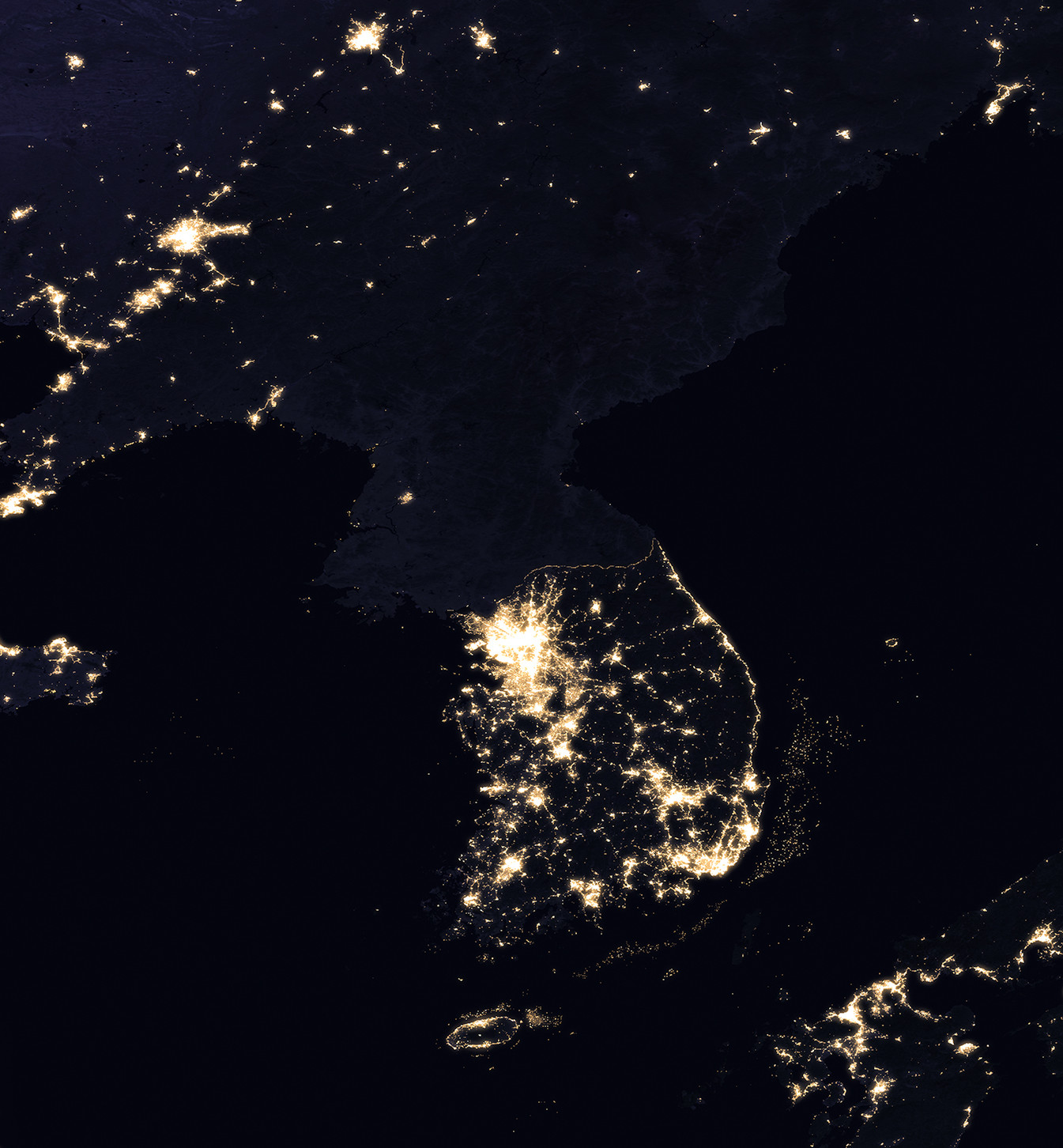 Satellite image of the Korean Peninsula at night, showing the difference in lighting between North and South Korea. This is often cited as an indicator of the disparity in economic development and energy availability.