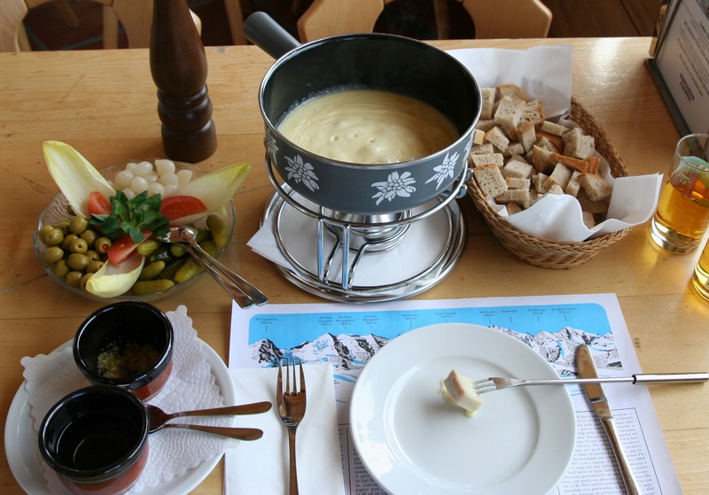 Fondue, a dish of melted cheese served in a communal pot, is a well-known Swiss specialty.