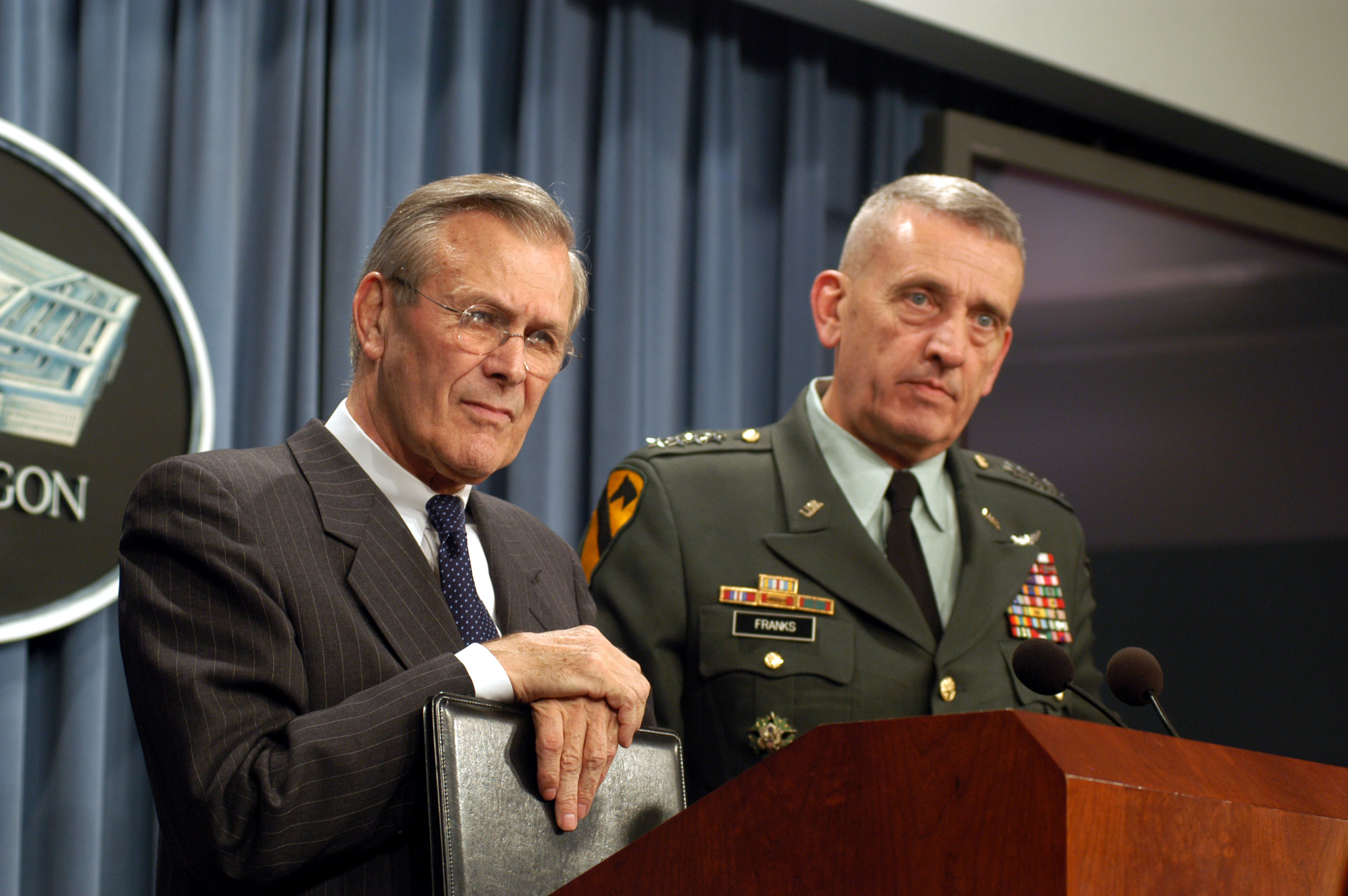 Rumsfeld (left) and General Tommy Franks (right), commander of United States Central Command, listen to a question at a Pentagon press conference on March 5, 2003.