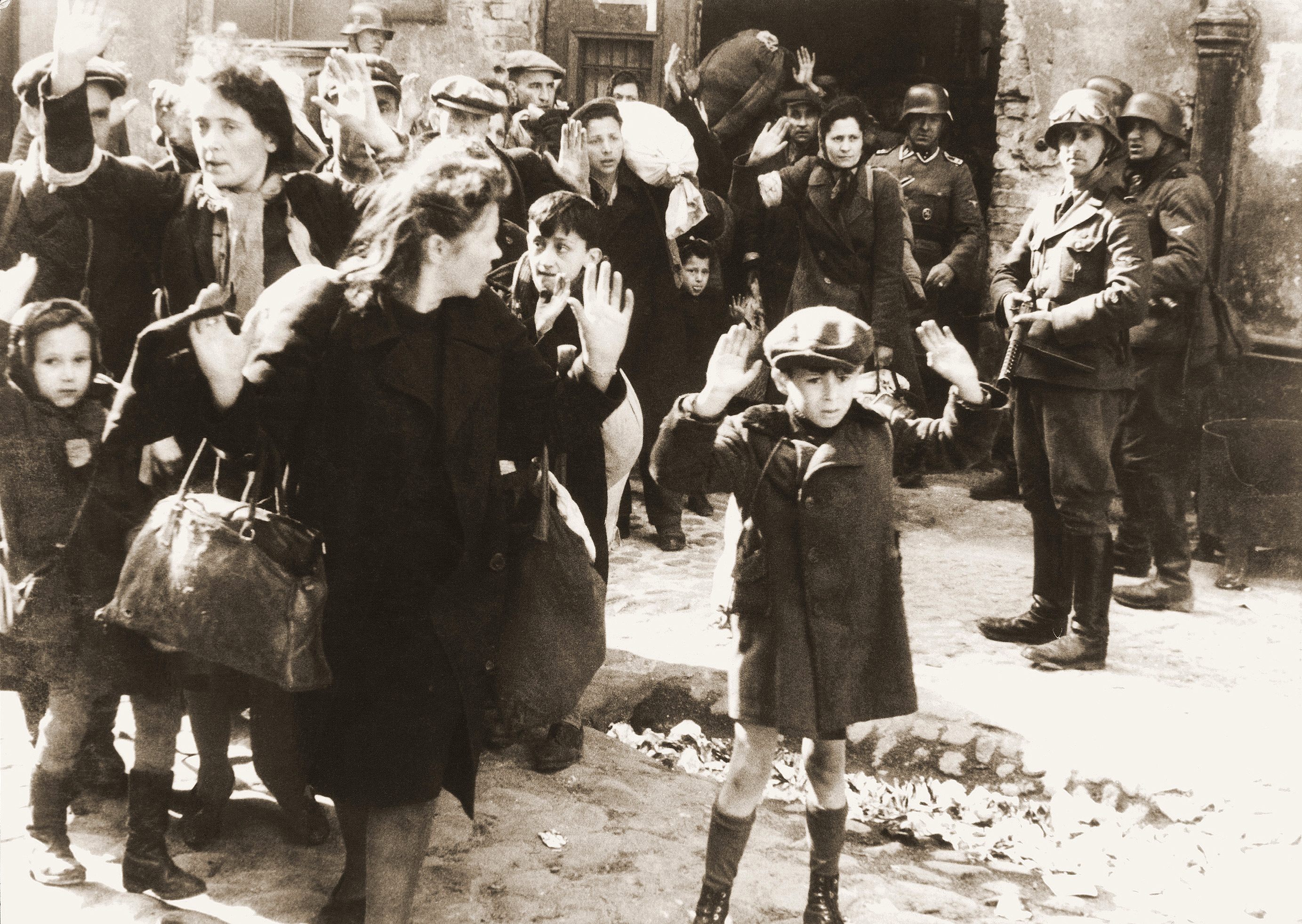 Iconic photograph of Jewish women and children being herded out of a building