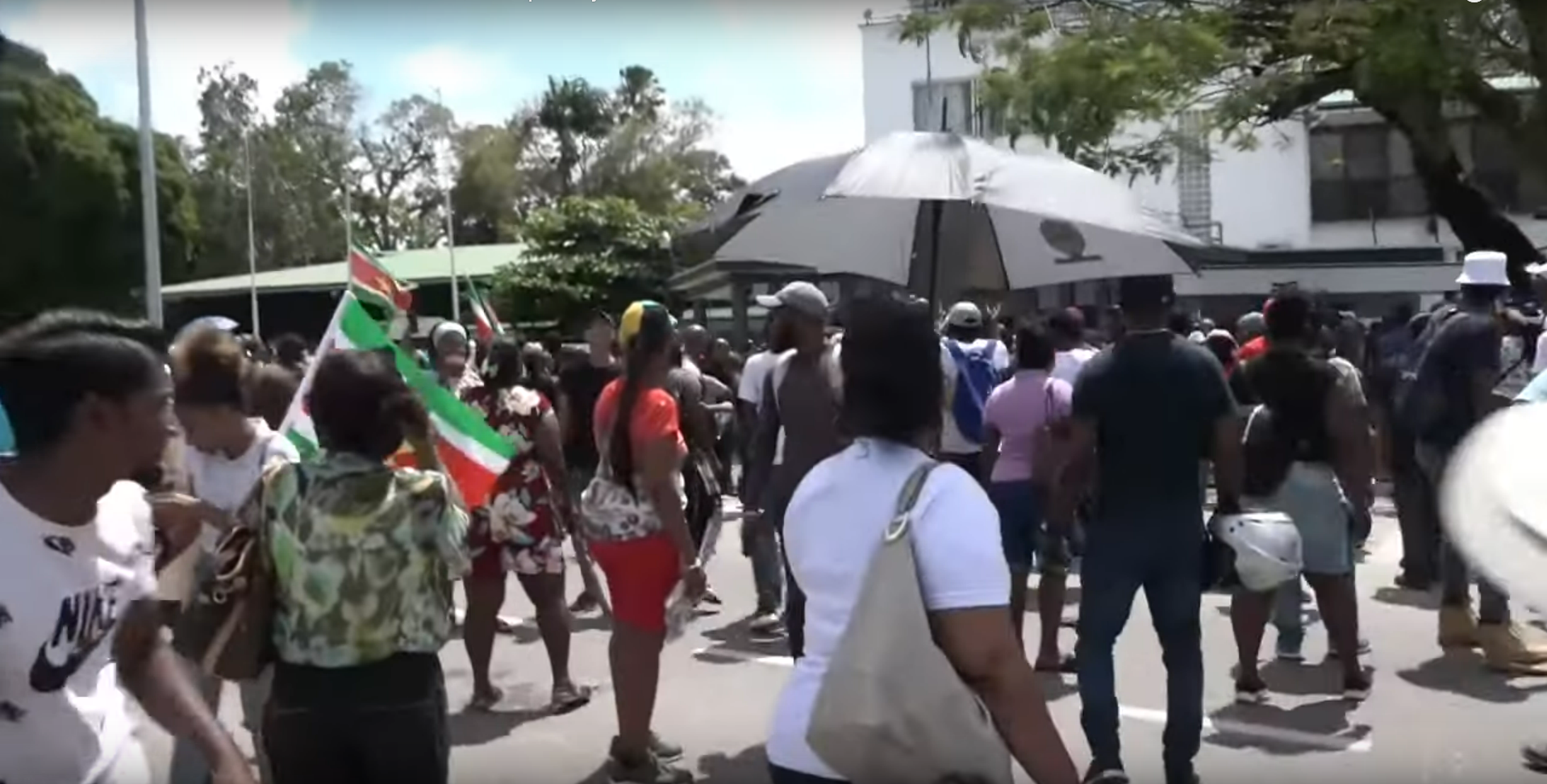 Protesters storming the National Assembly building in Paramaribo in February 2023, highlighting contemporary socio-economic frustrations.