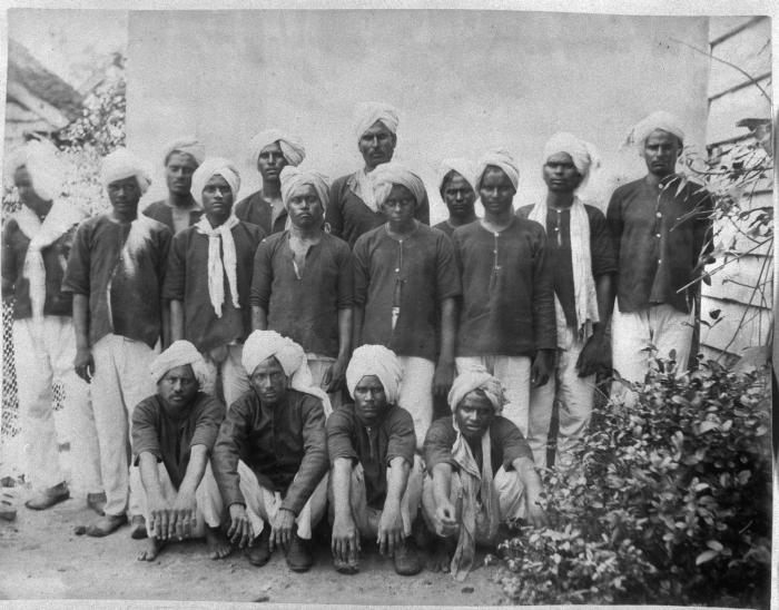 Immigrants from British India arriving in Suriname, late 19th or early 20th century, part of the indentured labor system that diversified the colony's population.