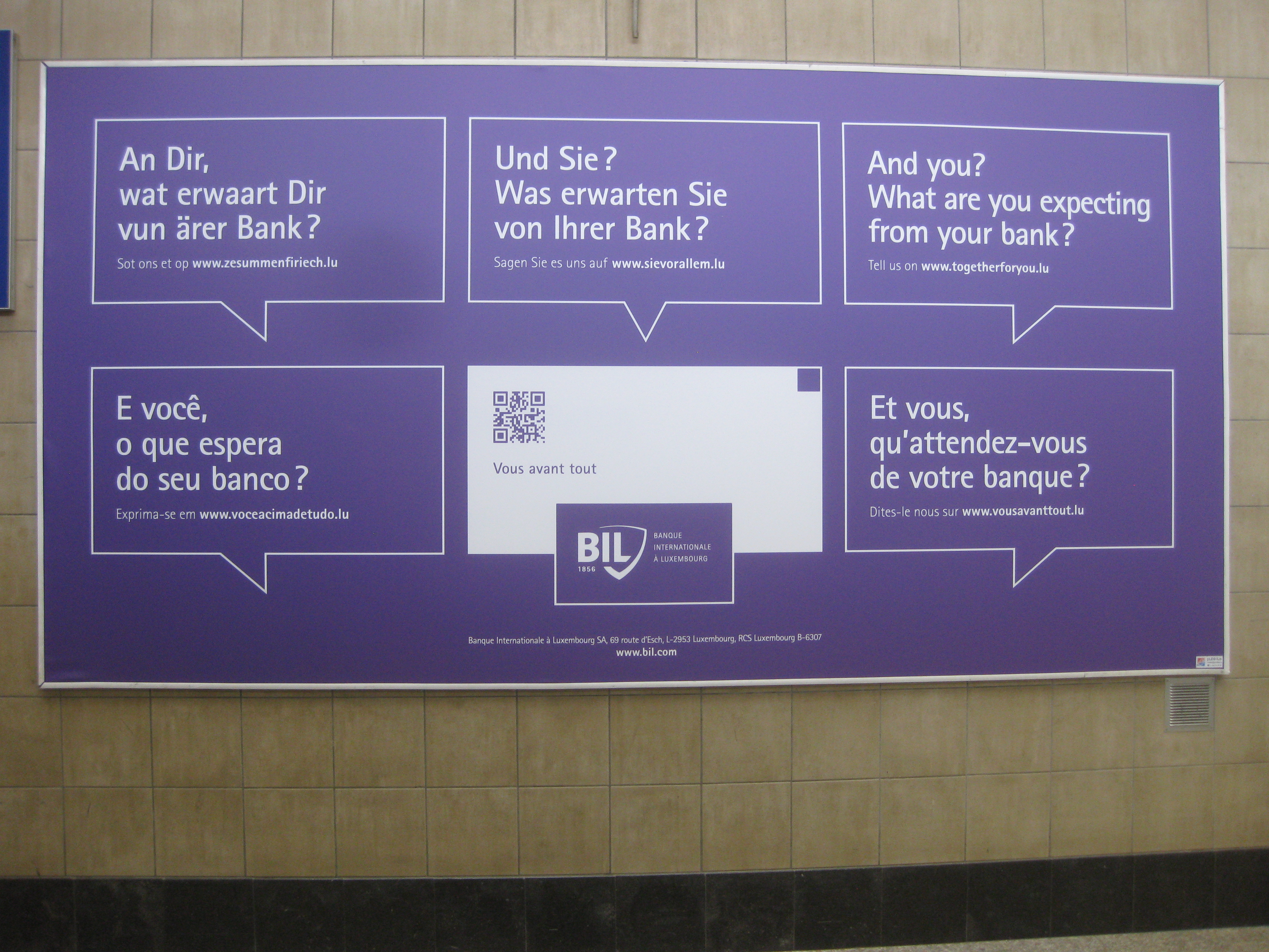 Advertisement from a bank in Luxembourg with translations in (clockwise from top left) Luxembourgish, German, English, French, and Portuguese