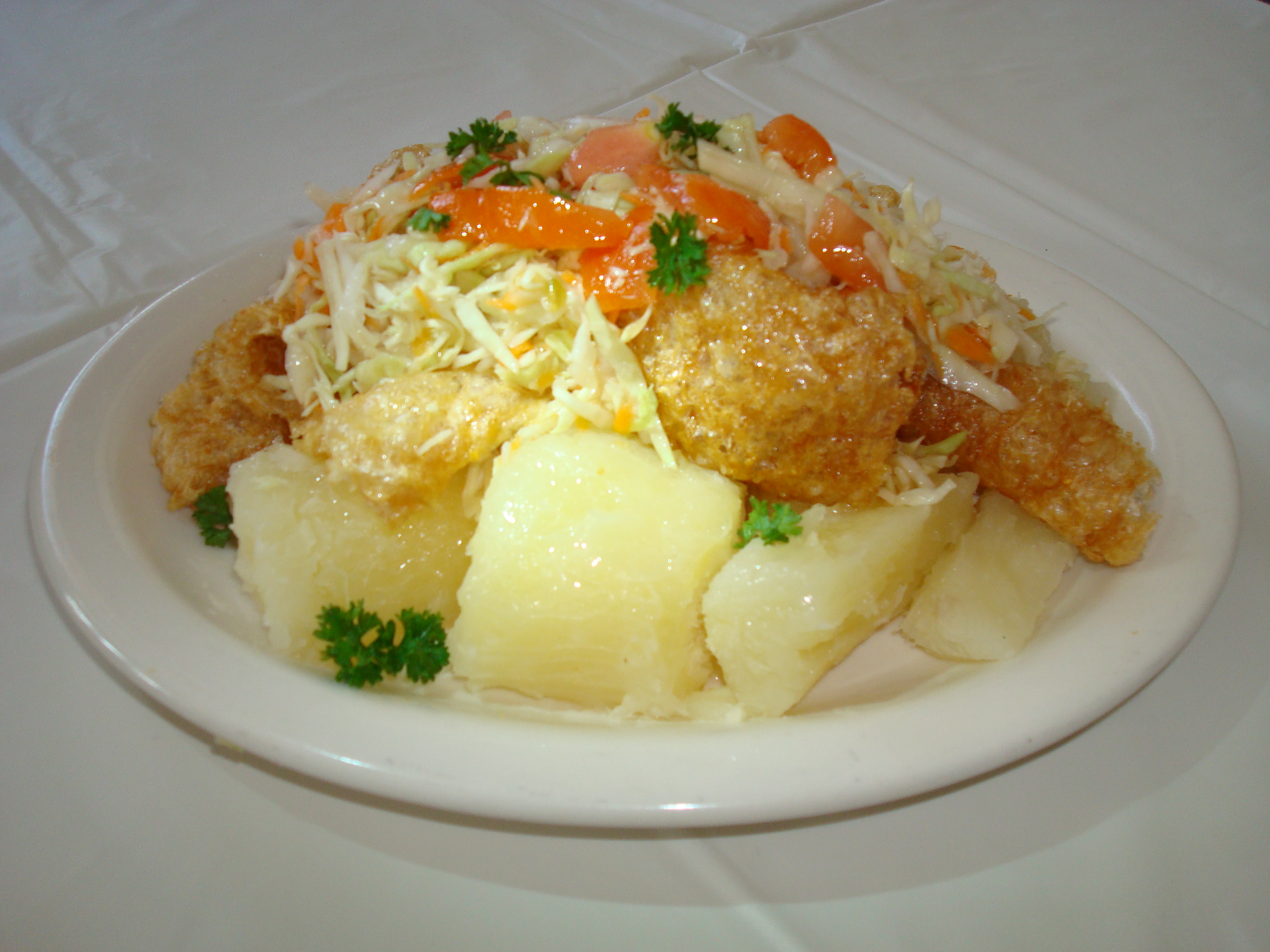 Vigorón, a traditional Nicaraguan dish typically consisting of boiled yuca (cassava) and chicharrones (fried pork rinds), topped with a cabbage salad.