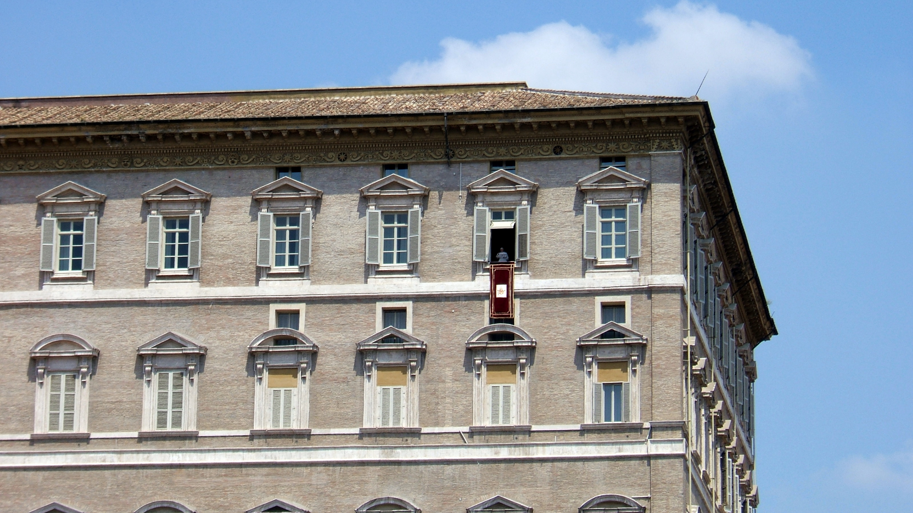 The Apostolic Palace (Palazzo Apostolico), the official residence of the Pope. Here, Benedict XVI is at the window marked by a maroon banner.
