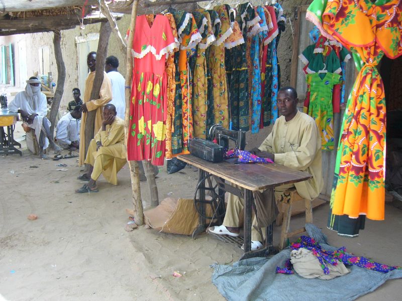 A Chadian tailor sells traditional dresses, representing local craftsmanship.