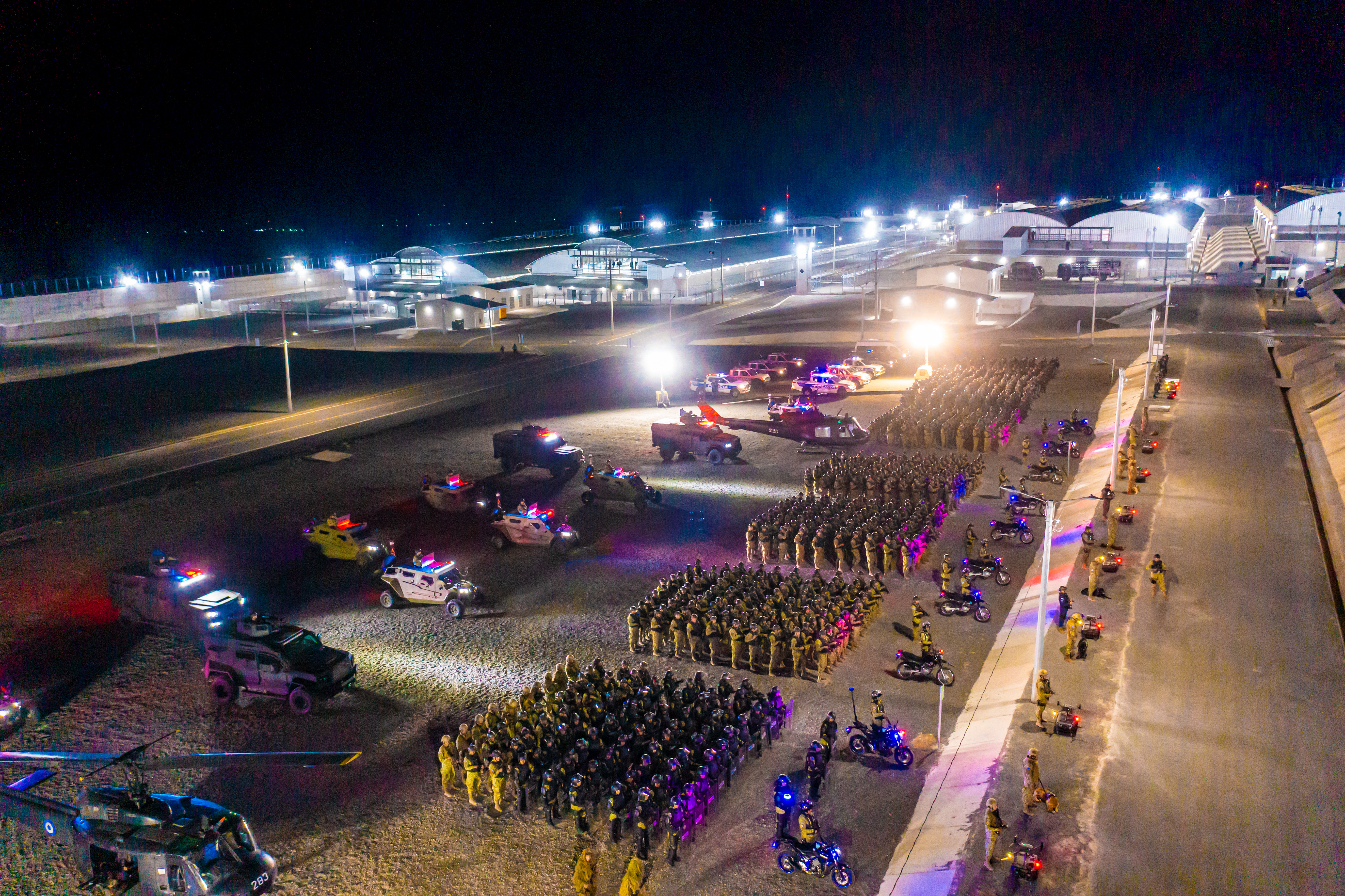 Soldiers and police officers outside the Terrorism Confinement Center (CECOT), illustrating the military's increased role in domestic security.