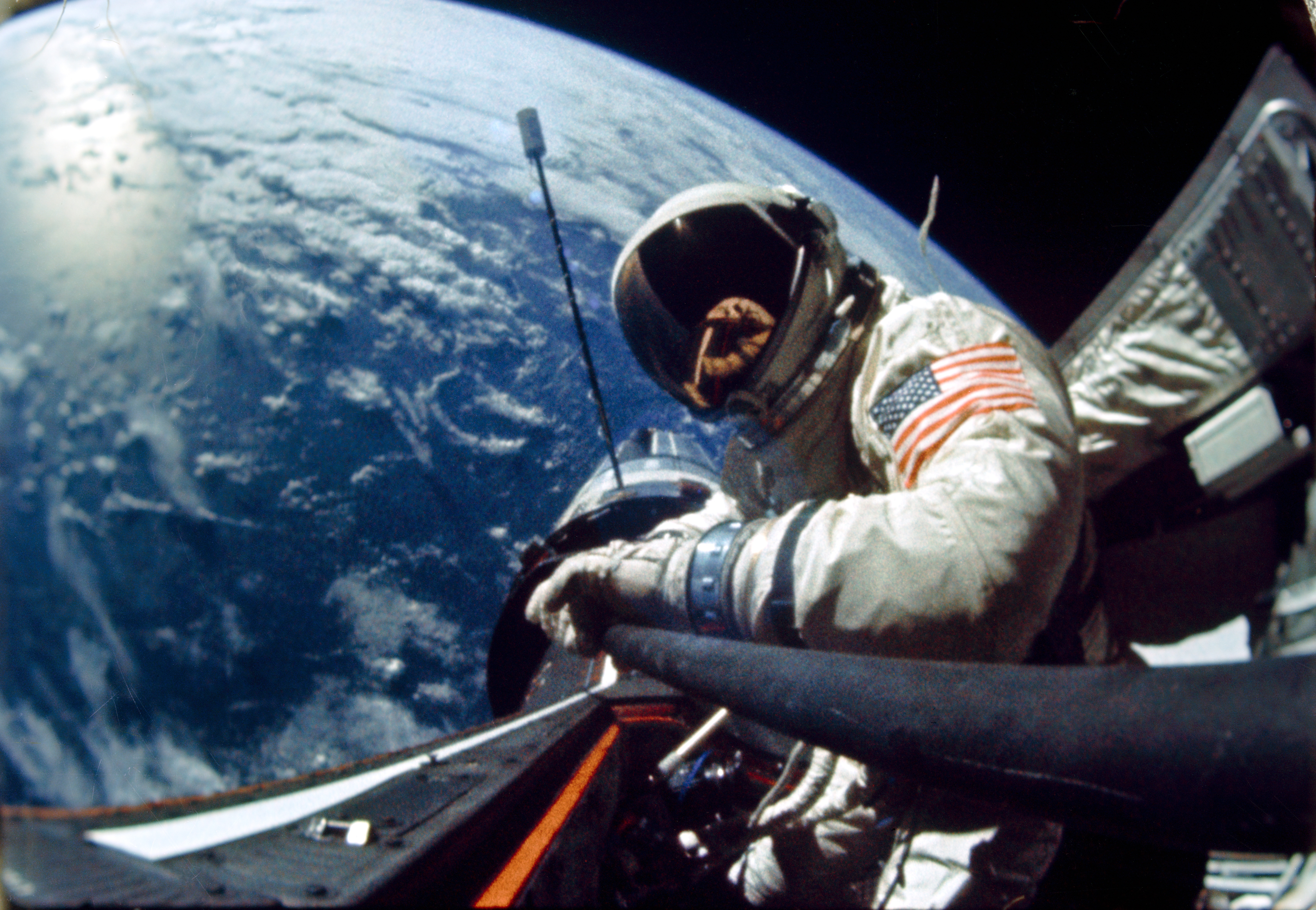 Aldrin stands in space while orbiting Earth in the Gemini 12 spacecraft.