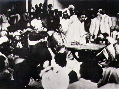 Sri Aurobindo seated at the table, with Tilak speaking: Surat session of Congress, 1907