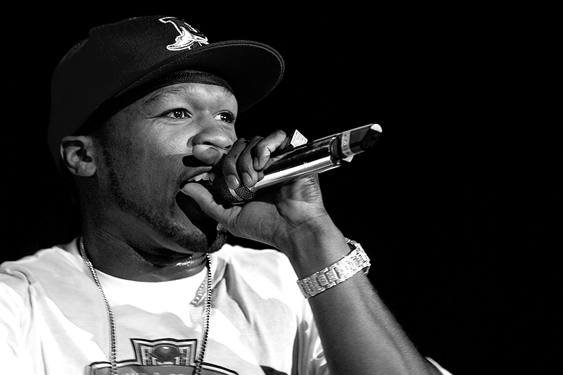 Black-and-white closeup of 50 Cent singing onstage