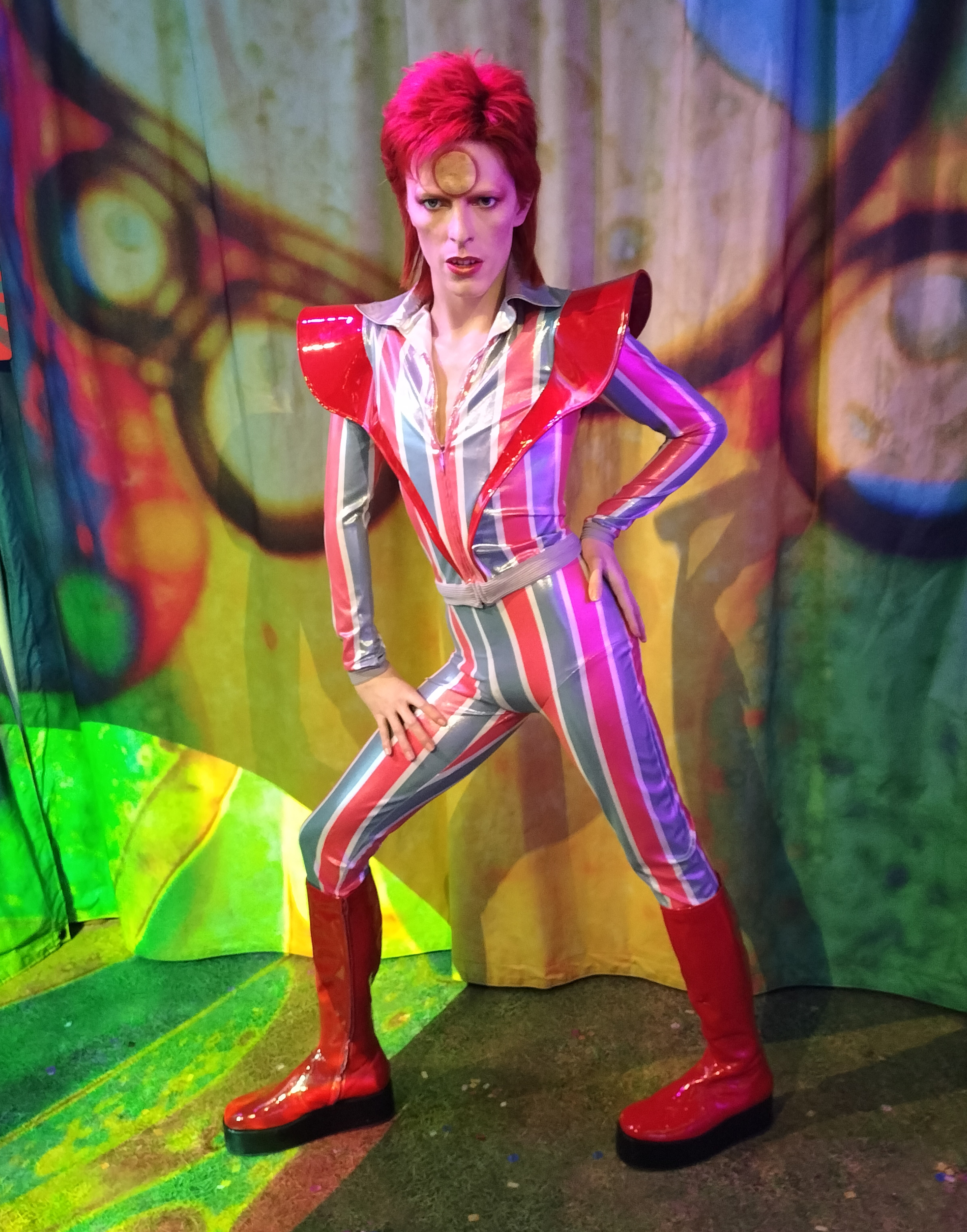 A wax figure of a red-haired man with a gold 