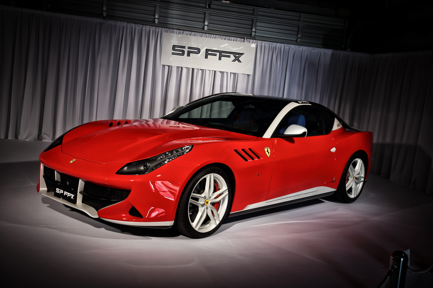 Front three-quarters view of a red coupe