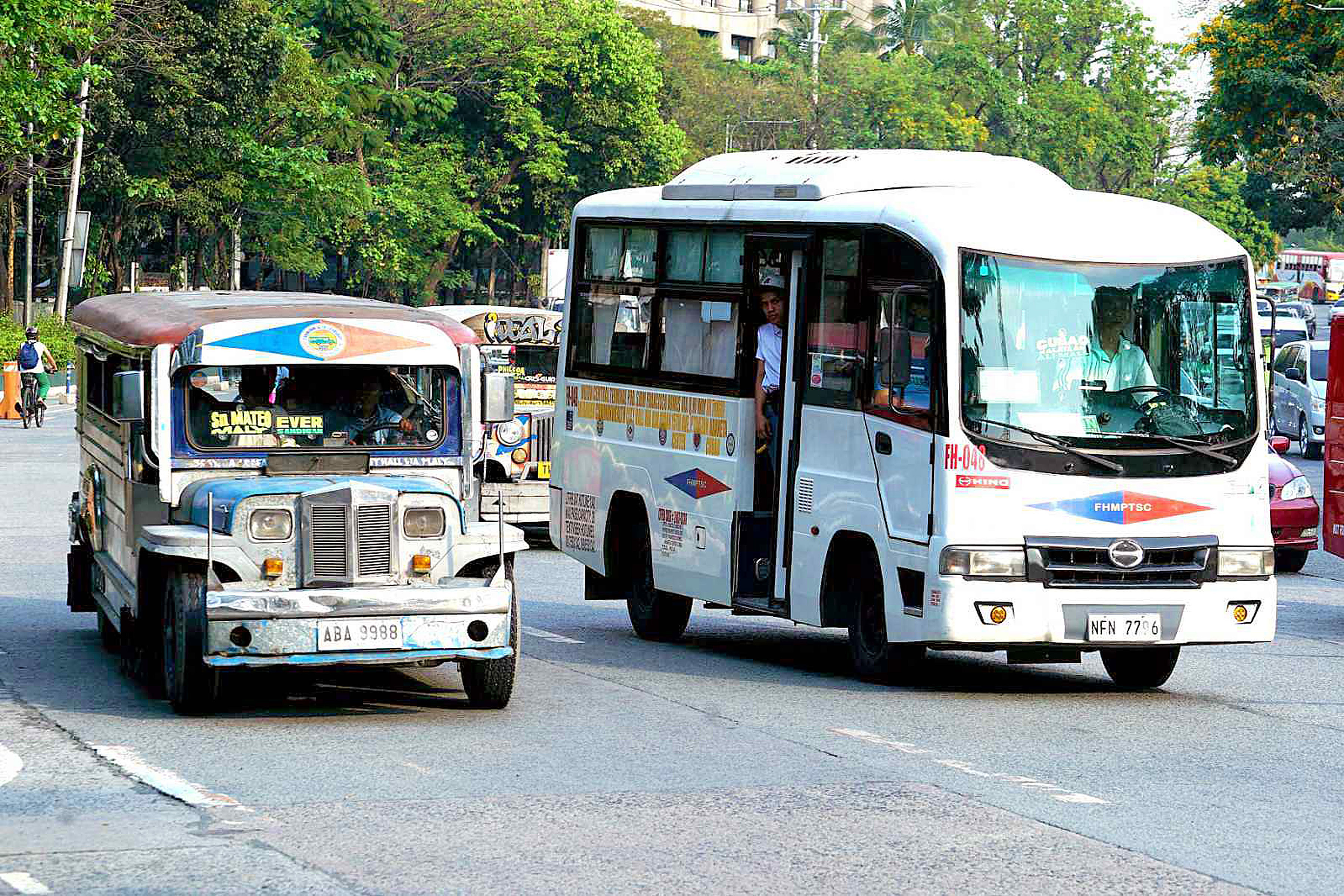Traditional (left) and modern jeepneys in Diliman, Quezon City. The Public Utility Vehicle Modernization Program aims to replace older, less efficient jeepneys with modern, eco-friendly vehicles.