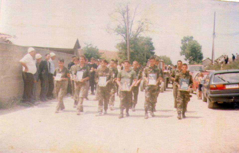 Kosovar Albanian women and children holding pictures of men killed or missing during the Krusha massacres in 1999.