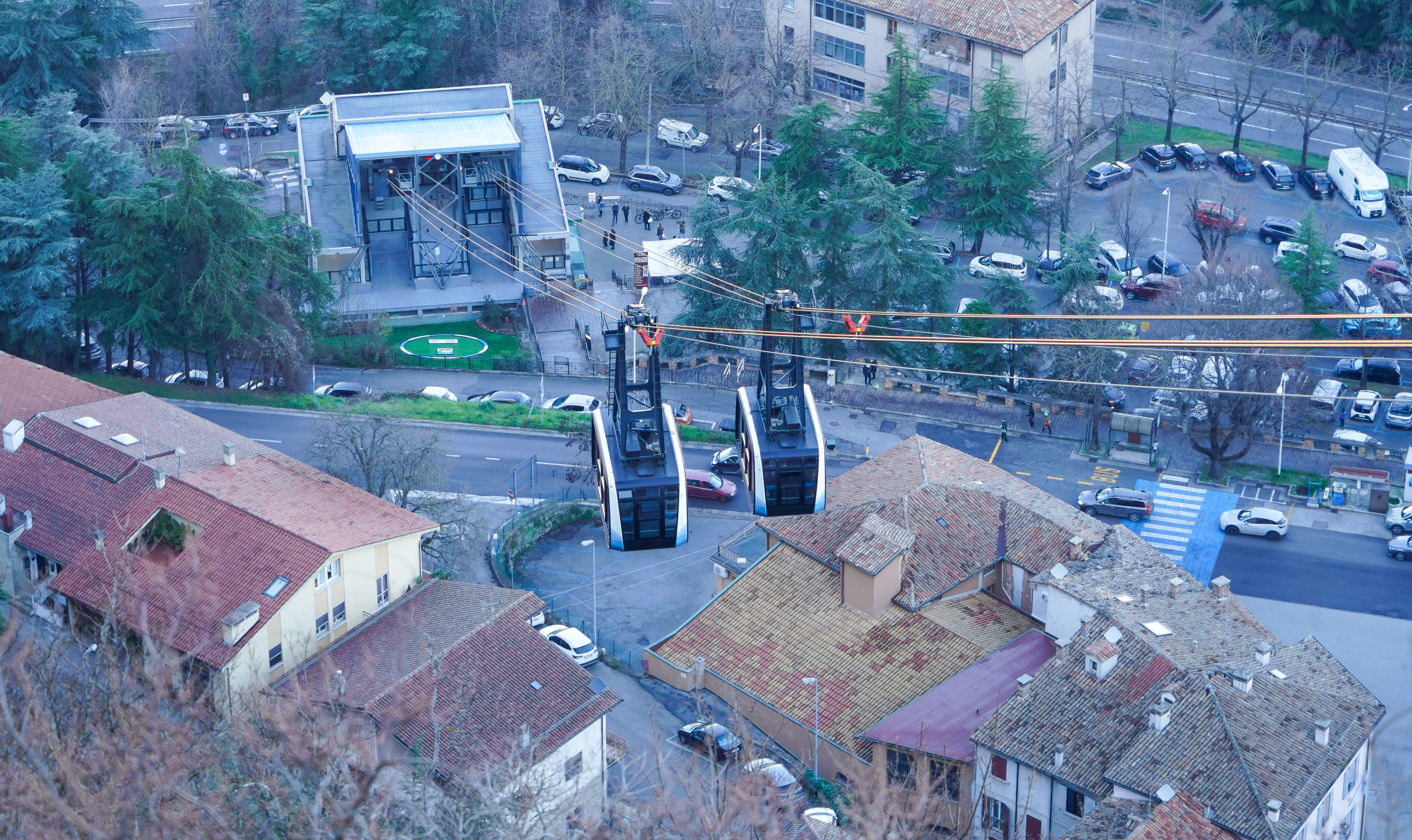 A cable car of the Funivia di San Marino overlooks Borgo Maggiore in April 2022.