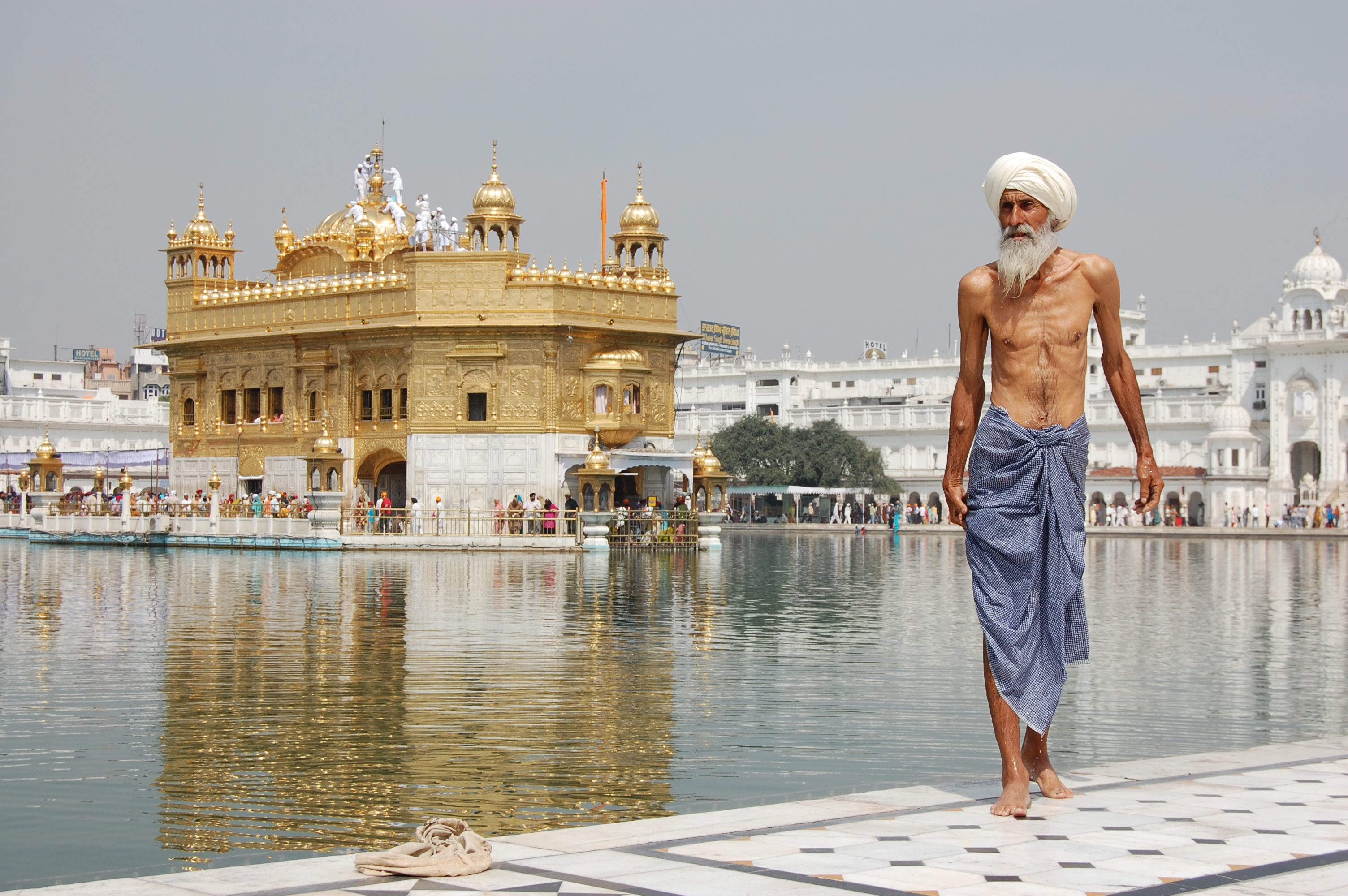 A Sikh pilgrim at the Harmandir Sahib (Golden Temple) in Amritsar, Punjab, a major spiritual center for Sikhism, a religion that emphasizes equality, service, and justice.