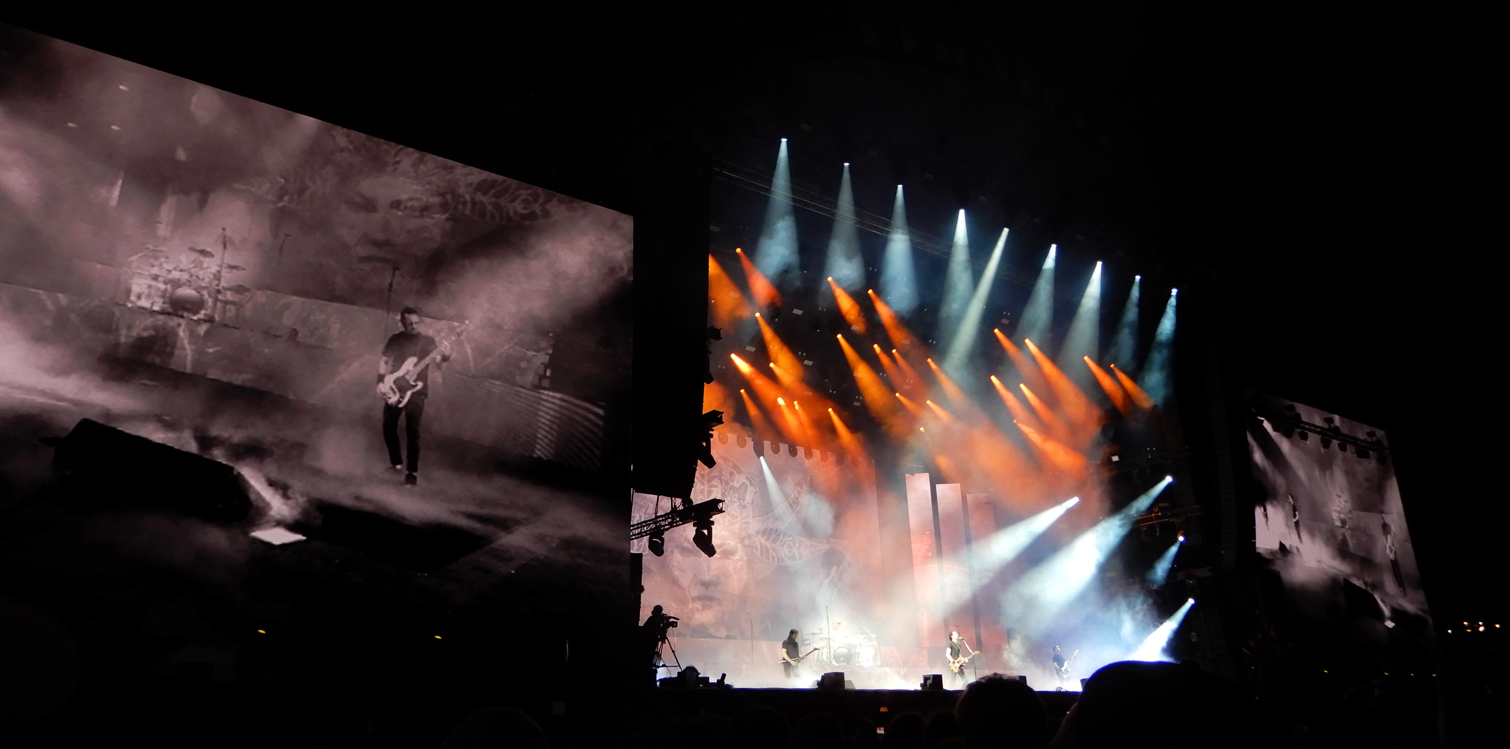 Gojira onstage, under orange and blue lights