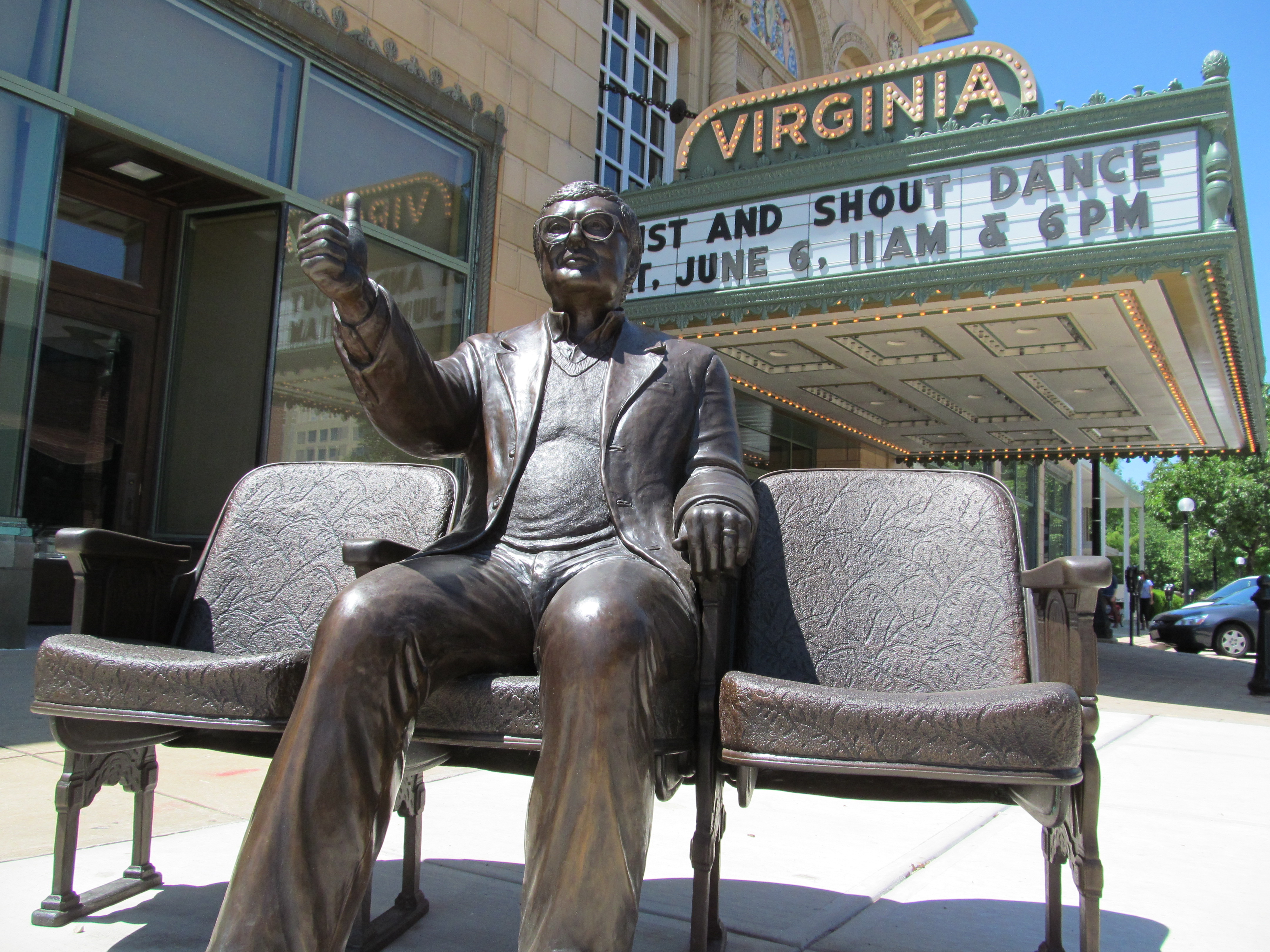 A statue of Roger Ebert giving his 