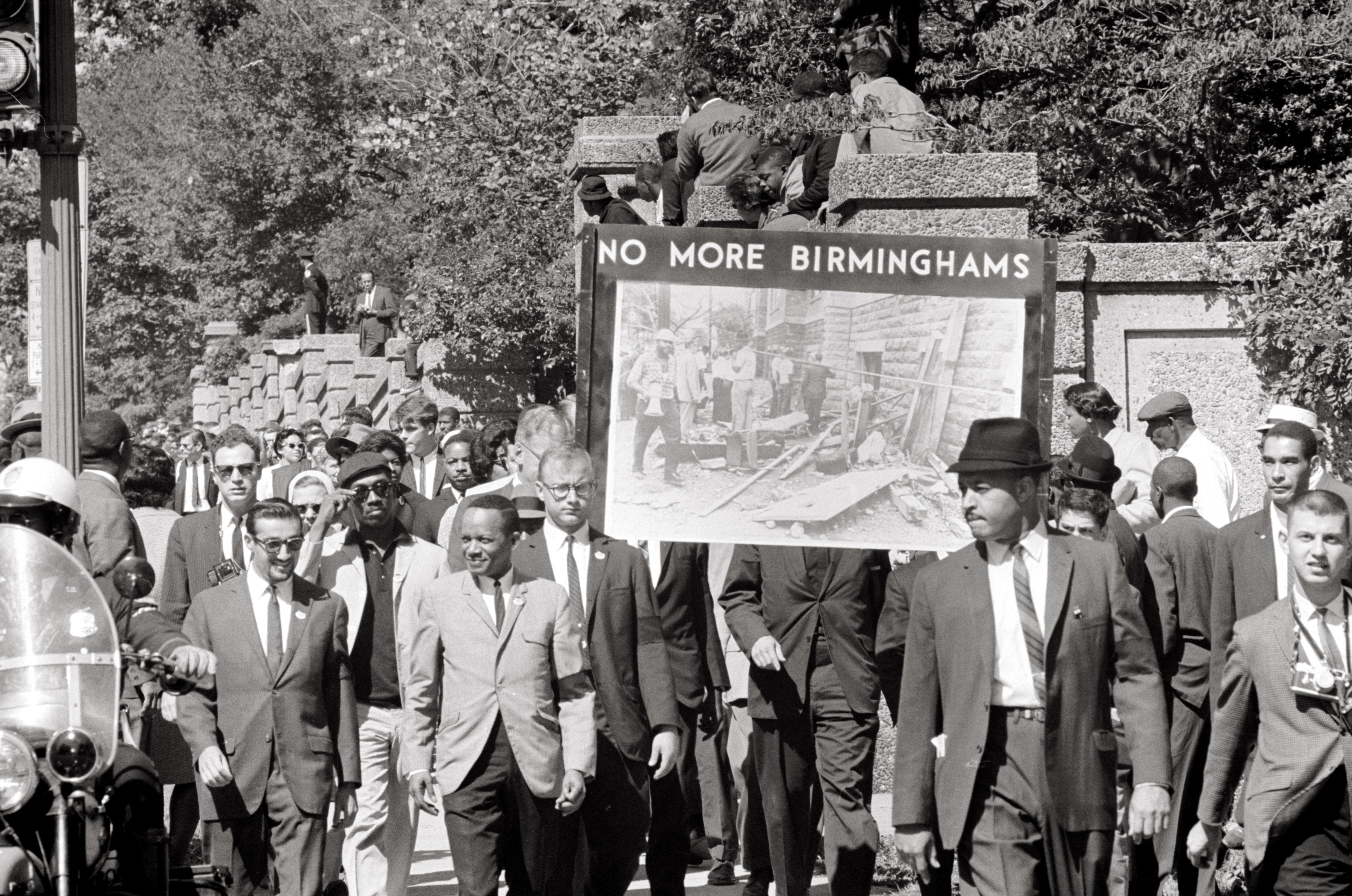 A protest march, with a sign 