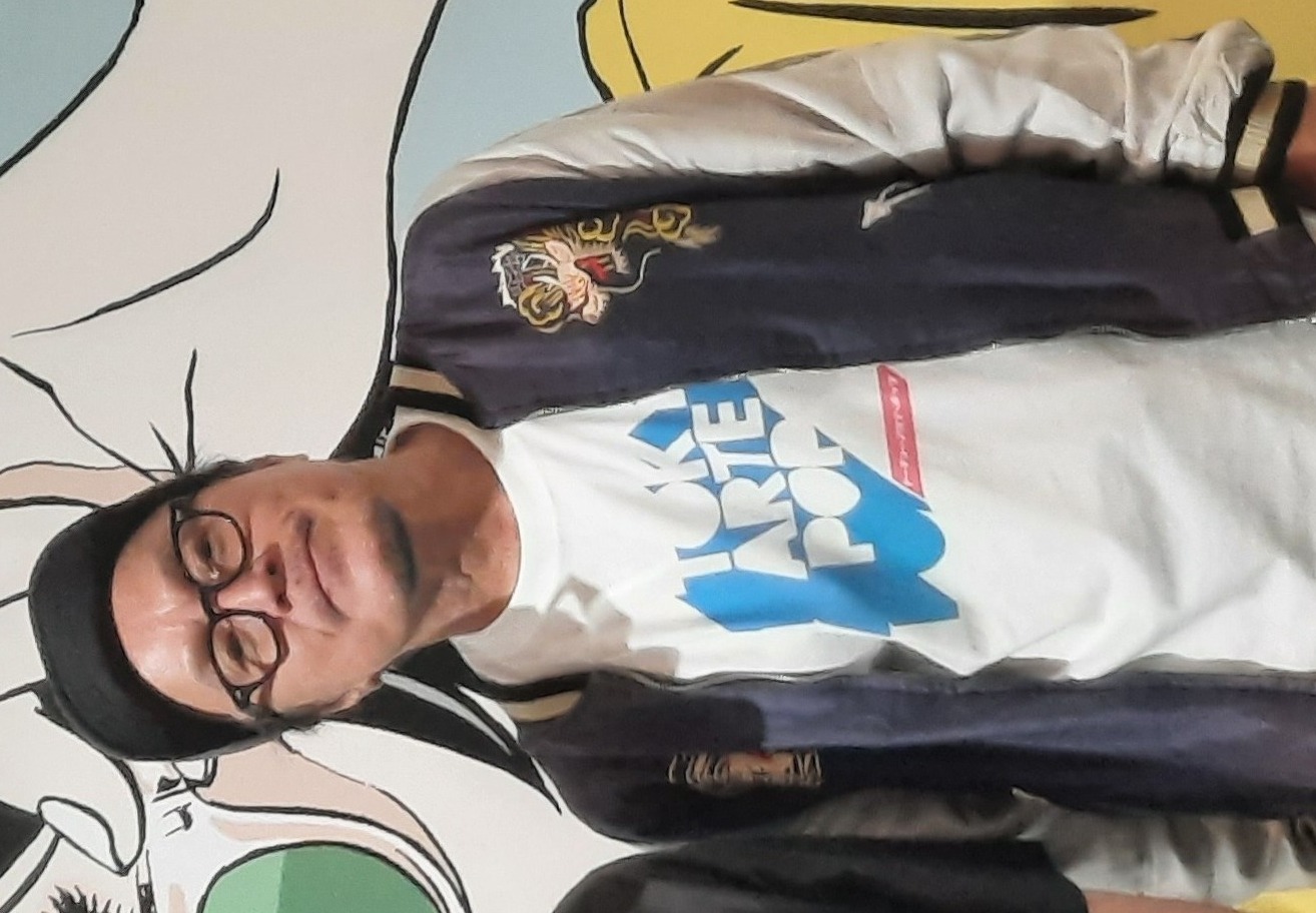 Hisashi Eguchi standing in a convention