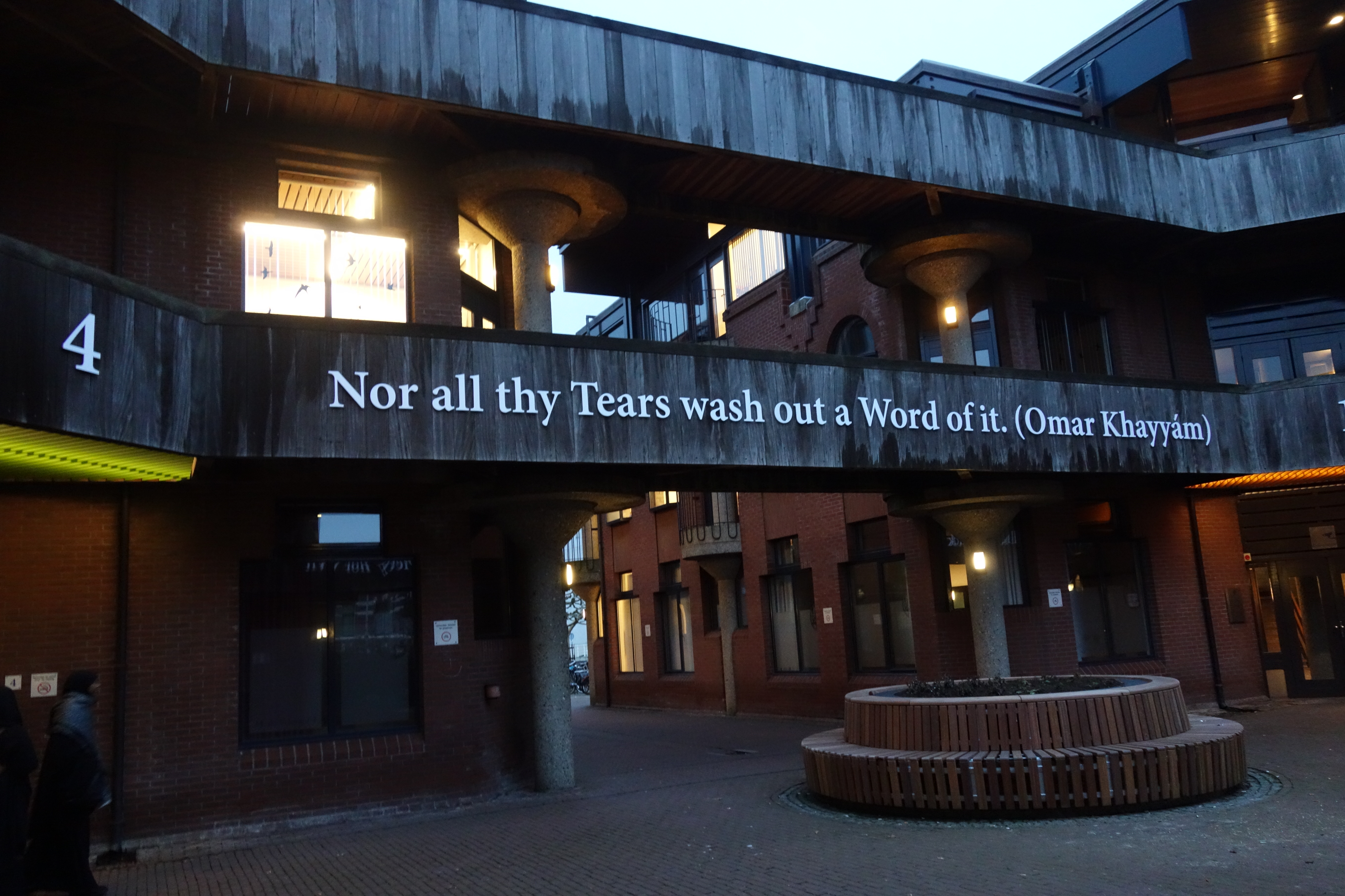 A line of English translation of The Moving Finger quatrain from the Rubaiyat of Omar Khayyam, displayed on a faculty building of Leiden University