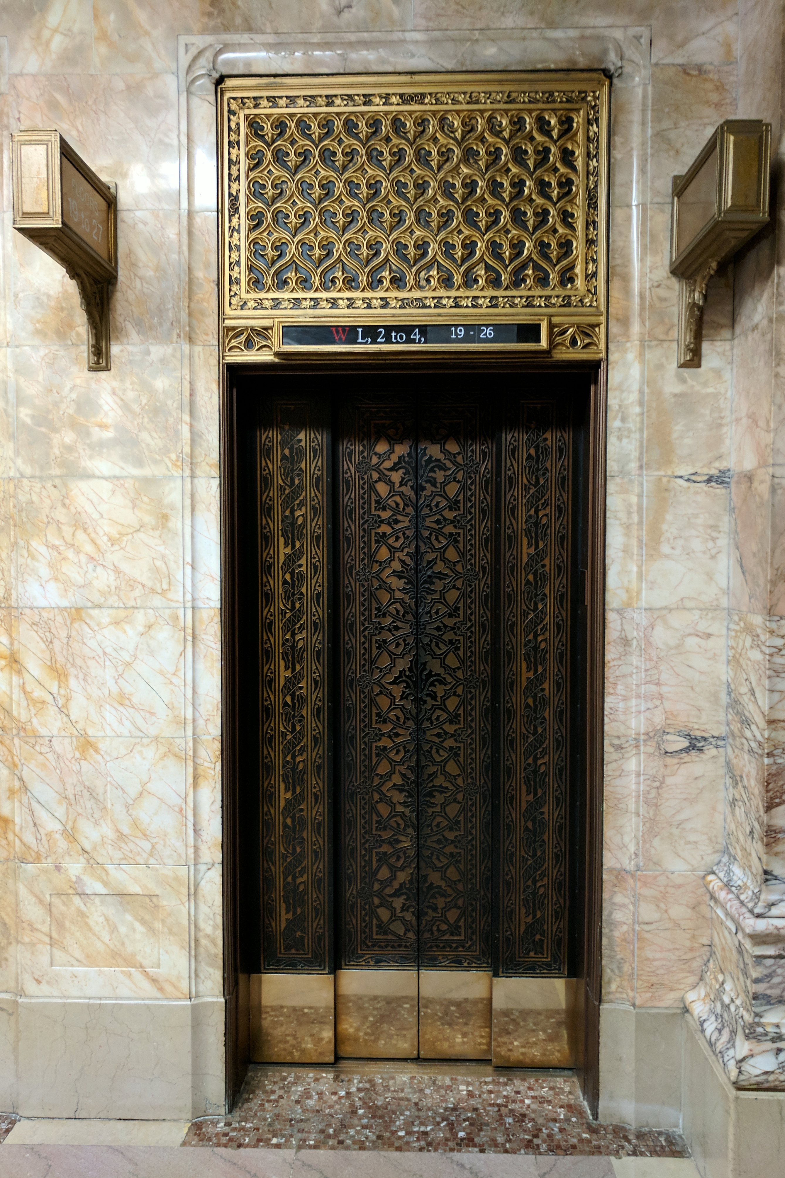 Photograph showing an ornately detailed elevator door