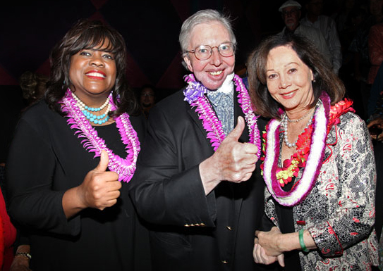 Ebert and his wife Chaz Hammelsmith Ebert (left) giving the thumbs up to Nancy Kwan (right) at the Hawaii International Film Festival in 2010
