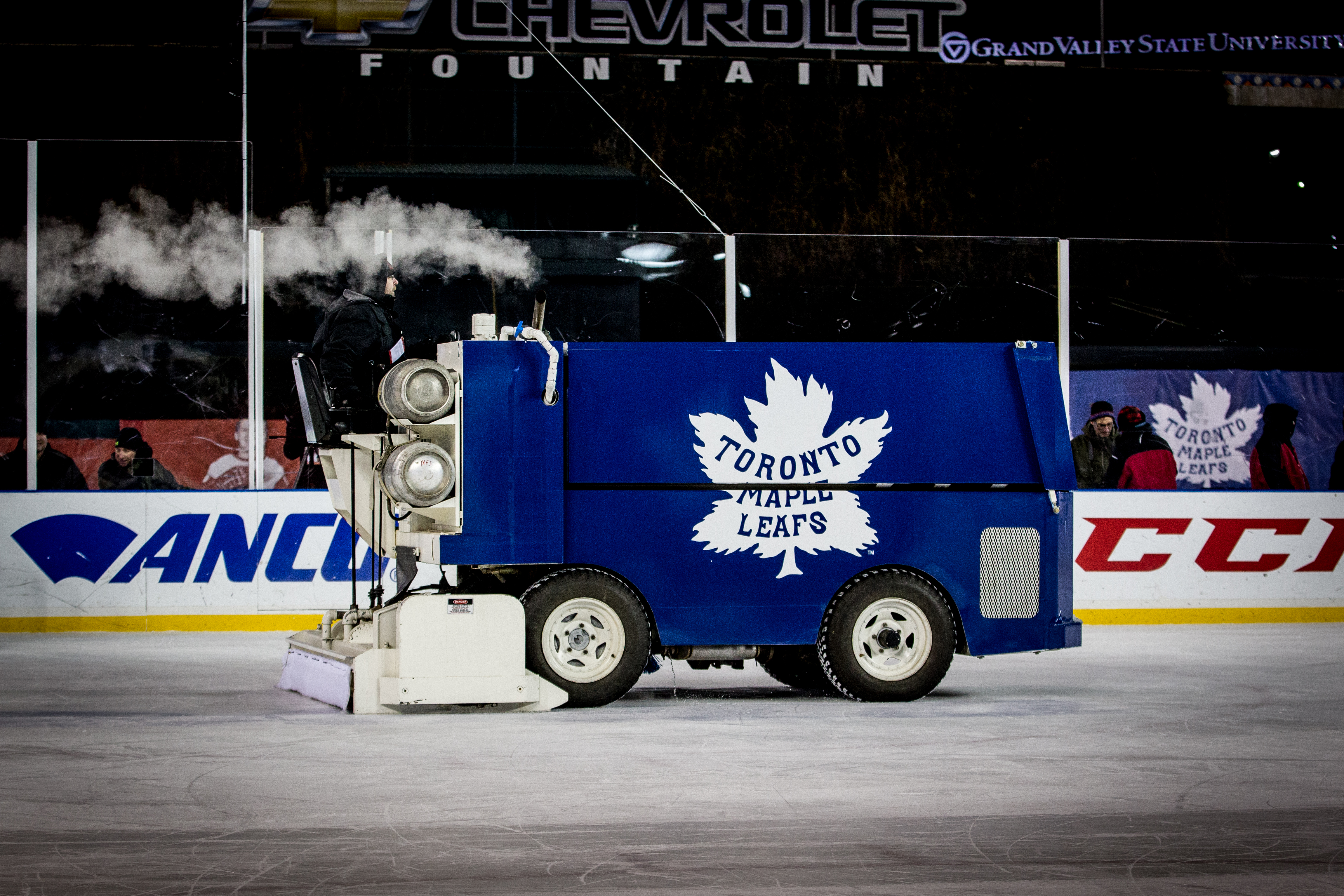 A blue-coloured zamboni with a Toronto Maple Leafs logo on its side.