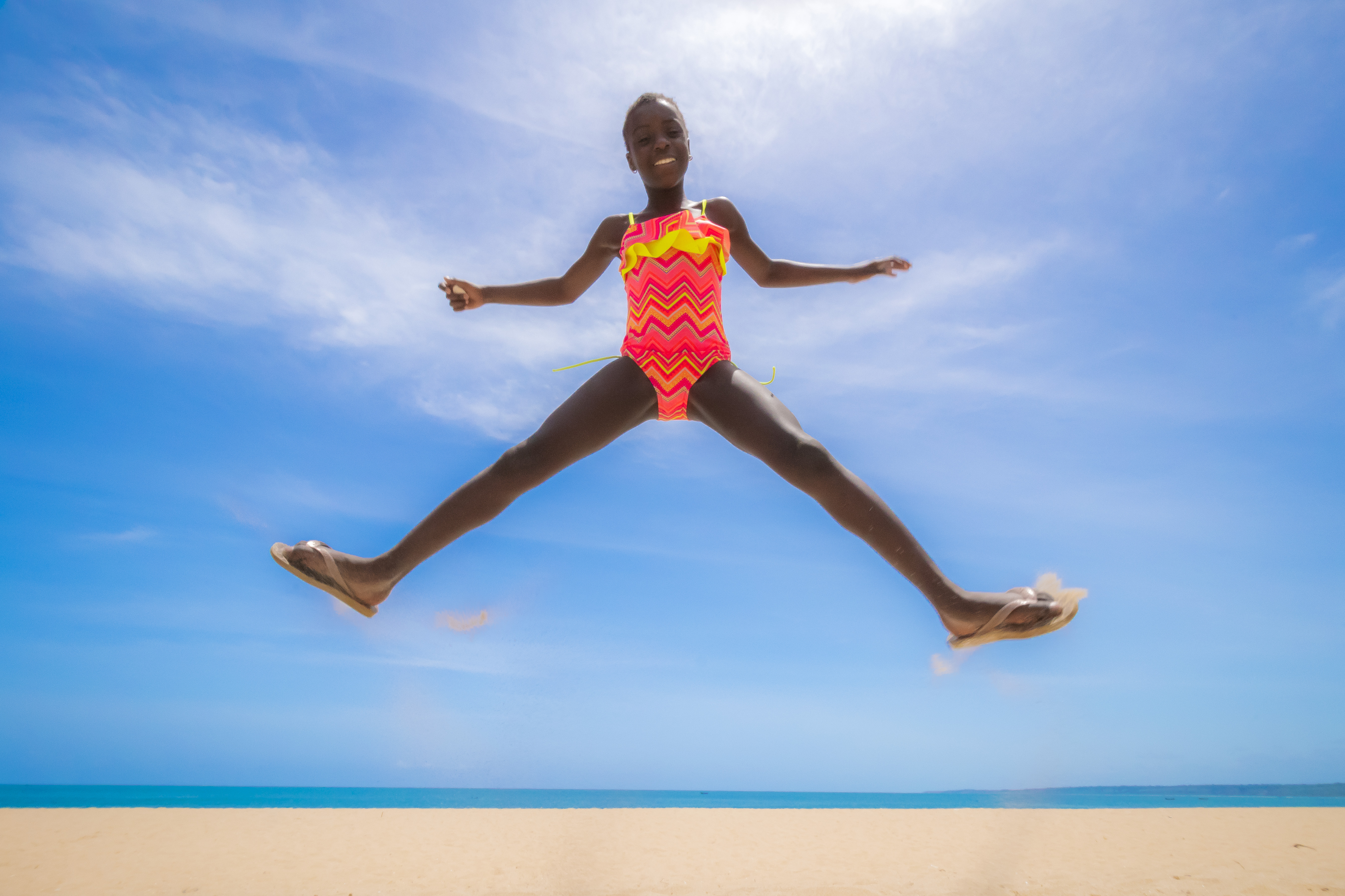 Girl wearing a pink and orange swimsuit