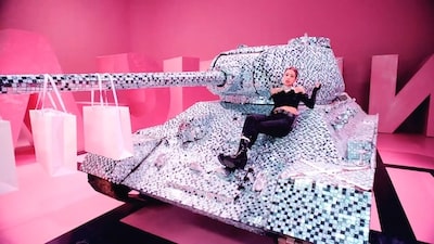 Jennie sitting atop a diamond-encrusted tank on the set of the music video