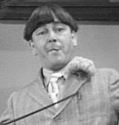 Moe playing harmonica in Disorder in the Court in 1936