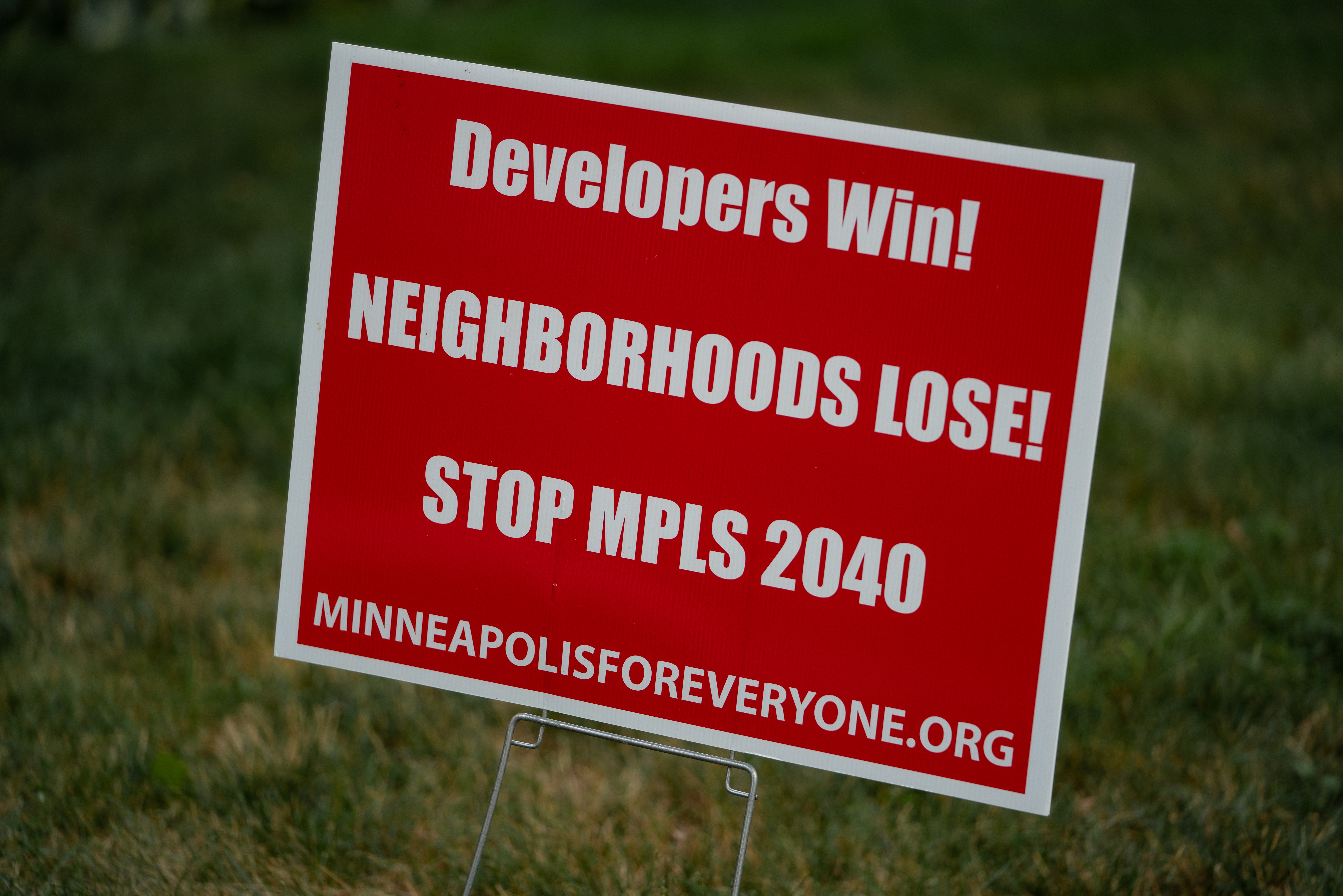 A lawn sign reads, 