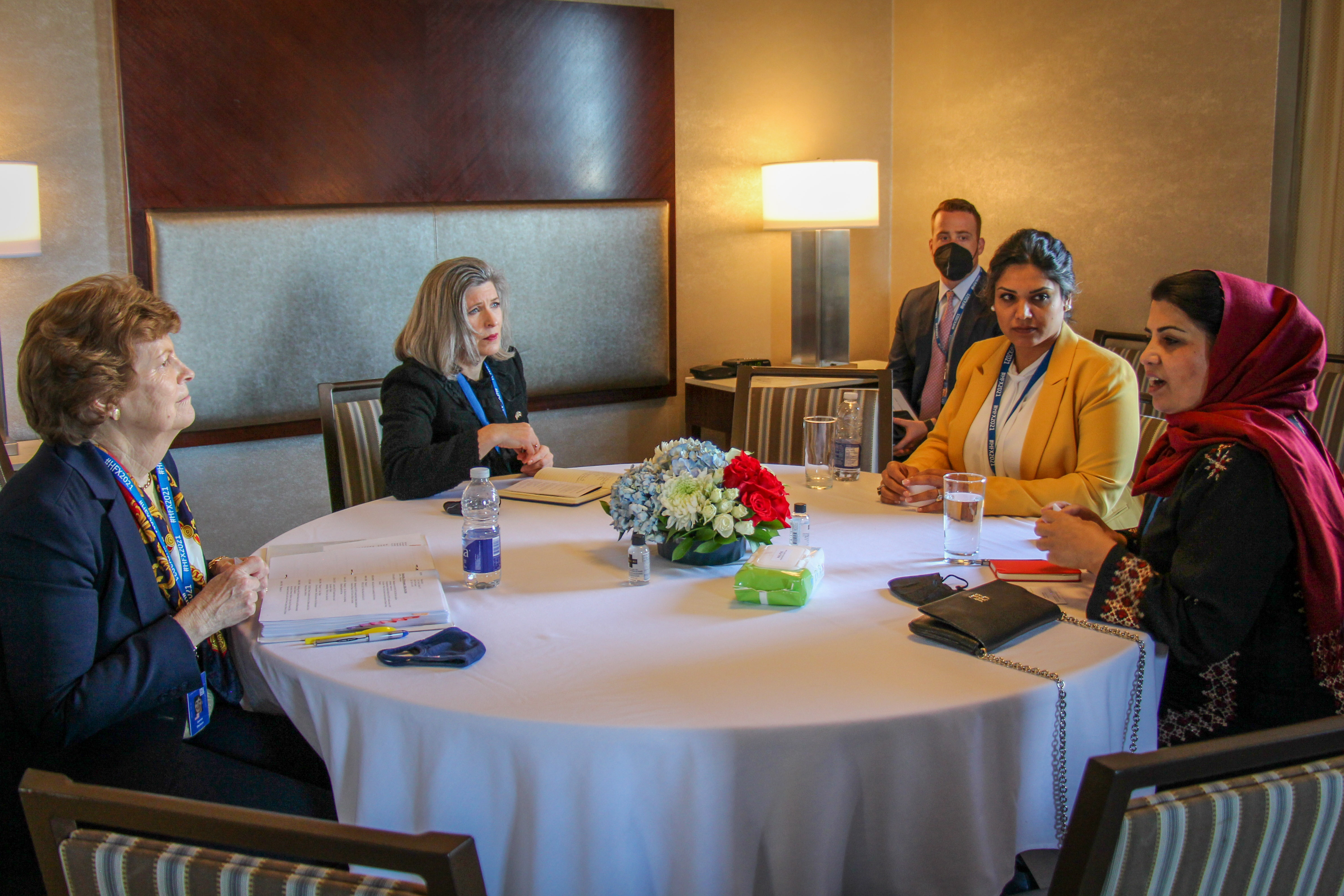 Shaheen and Senator Joni Ernst in a meeting with Afghan women, 2021