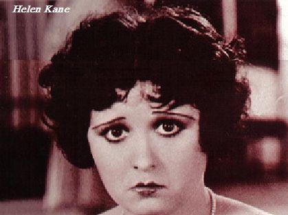 A close-up of Kane with short black hair like Boop, making a sad expression